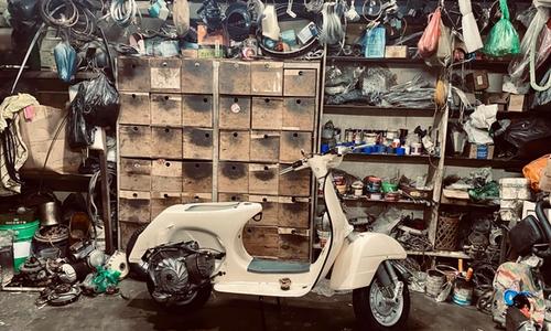 a Vespa in a workshop