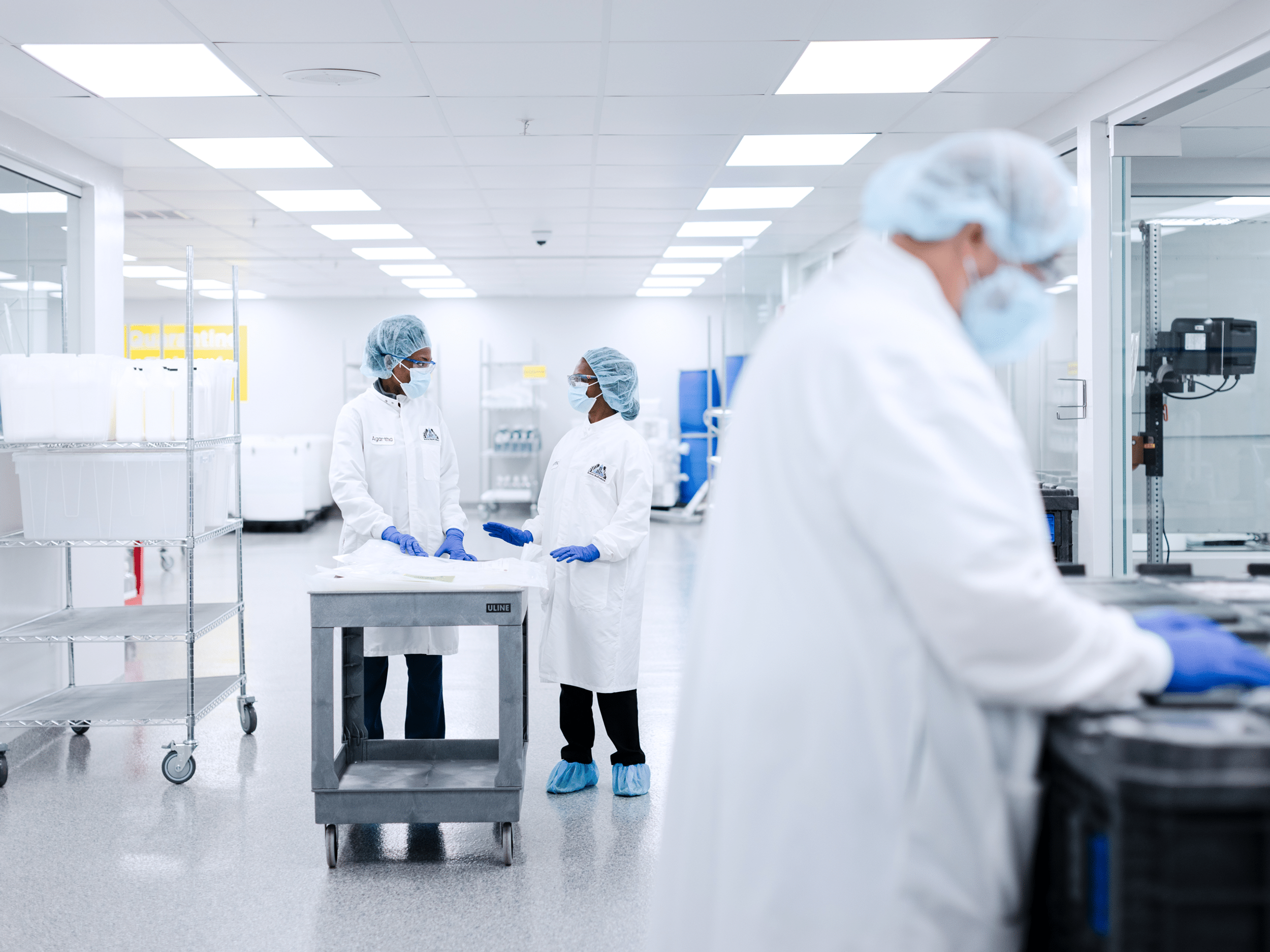 Researchers operating upstream bioprocessing equipment in a lab