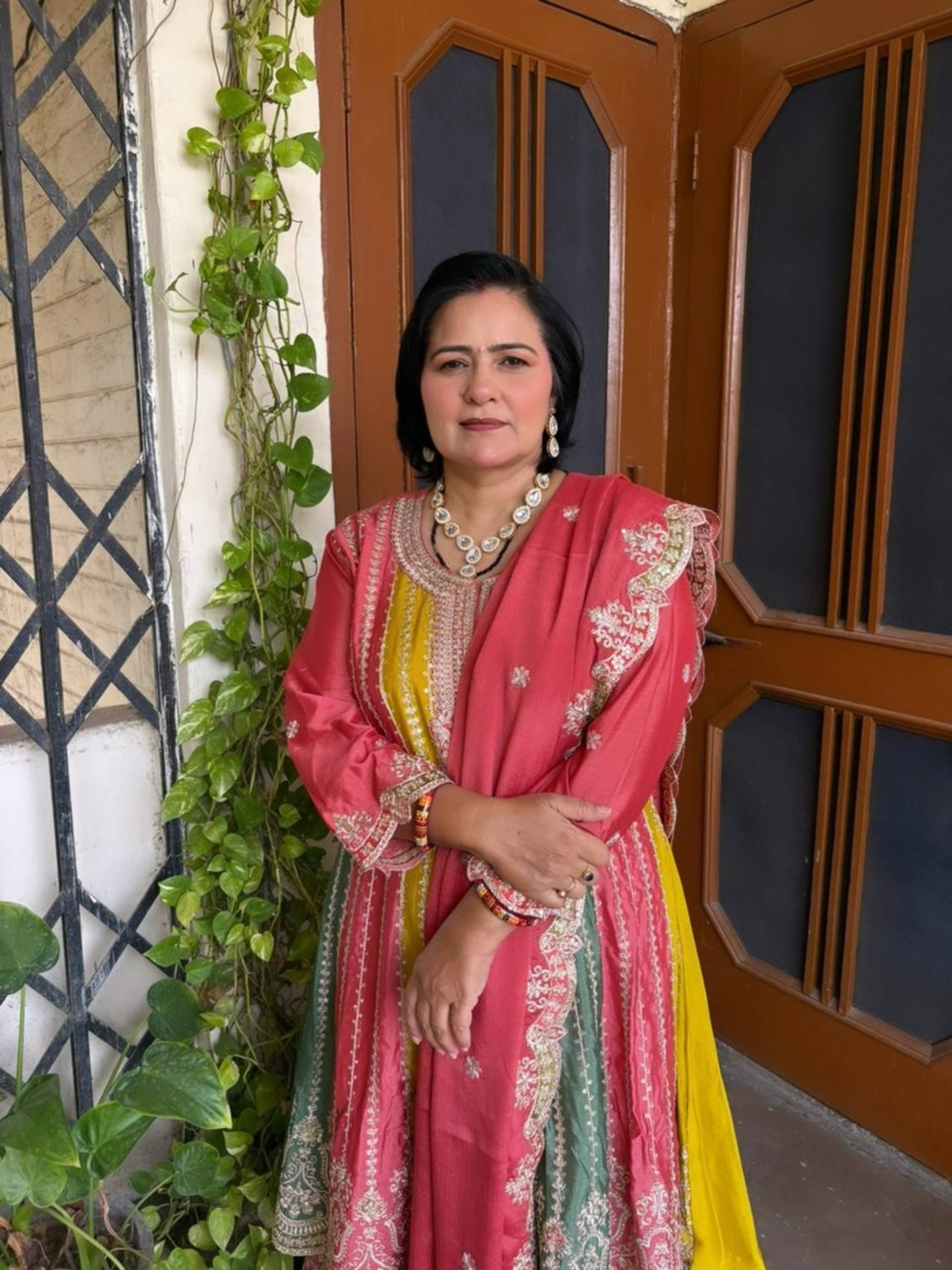 Festive party makeup with soft natural glam, paired with a coral and yellow suit, by Priya Maleri in Tricity