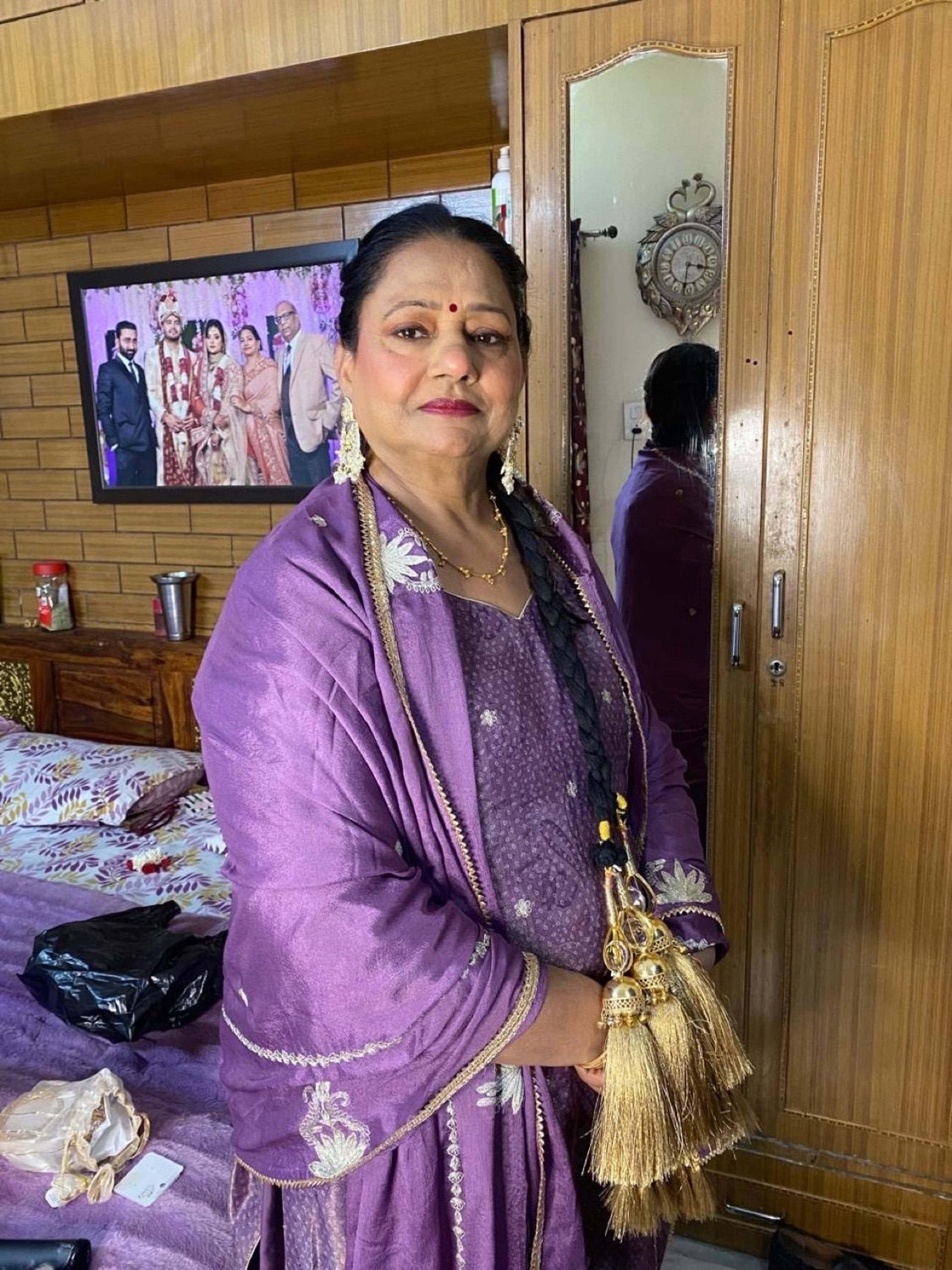 Elegant traditional makeup for a family guest in a purple suit, by Priya Maleri
