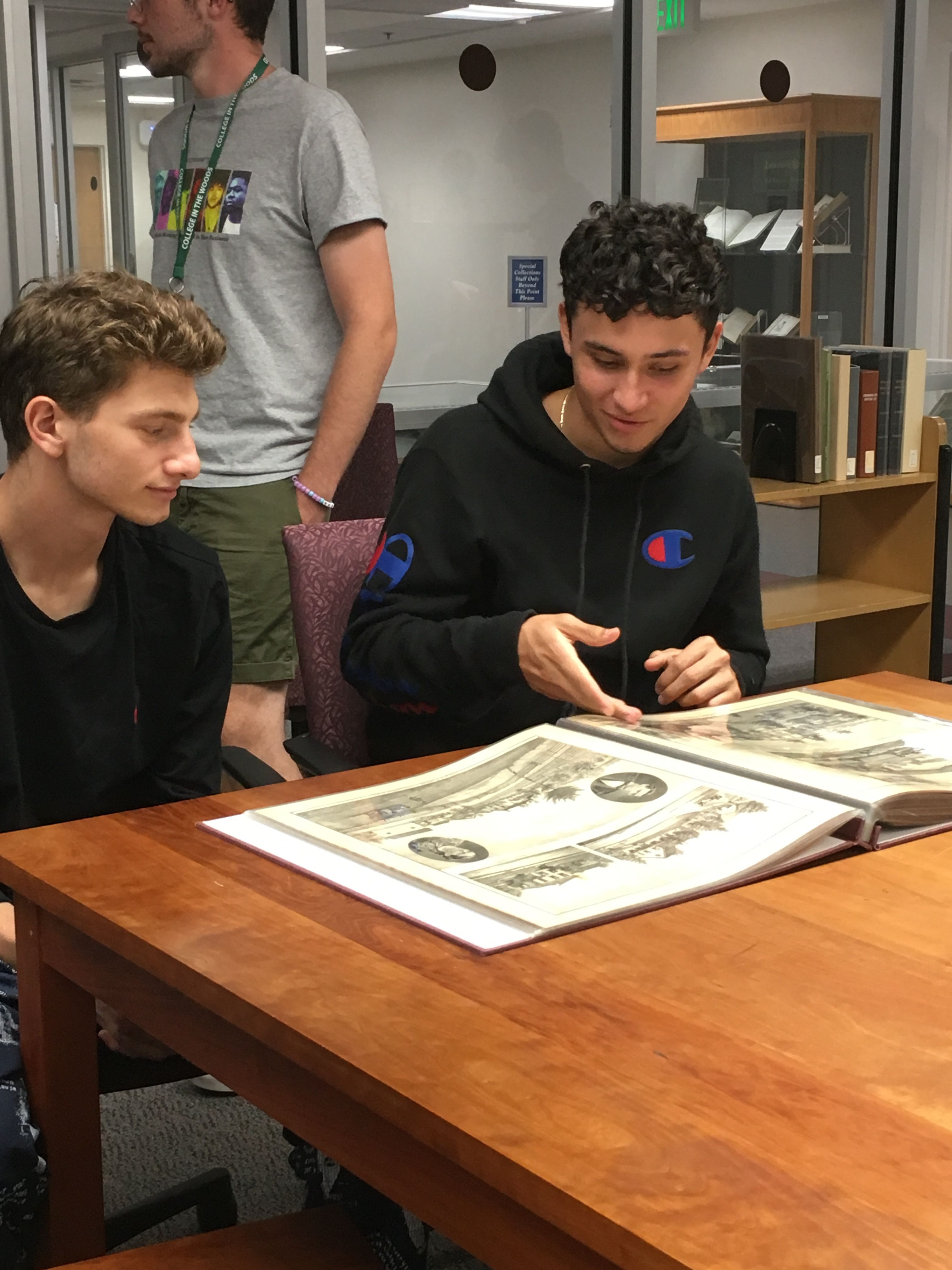 Students look at historical maps from Special Collections in the university library