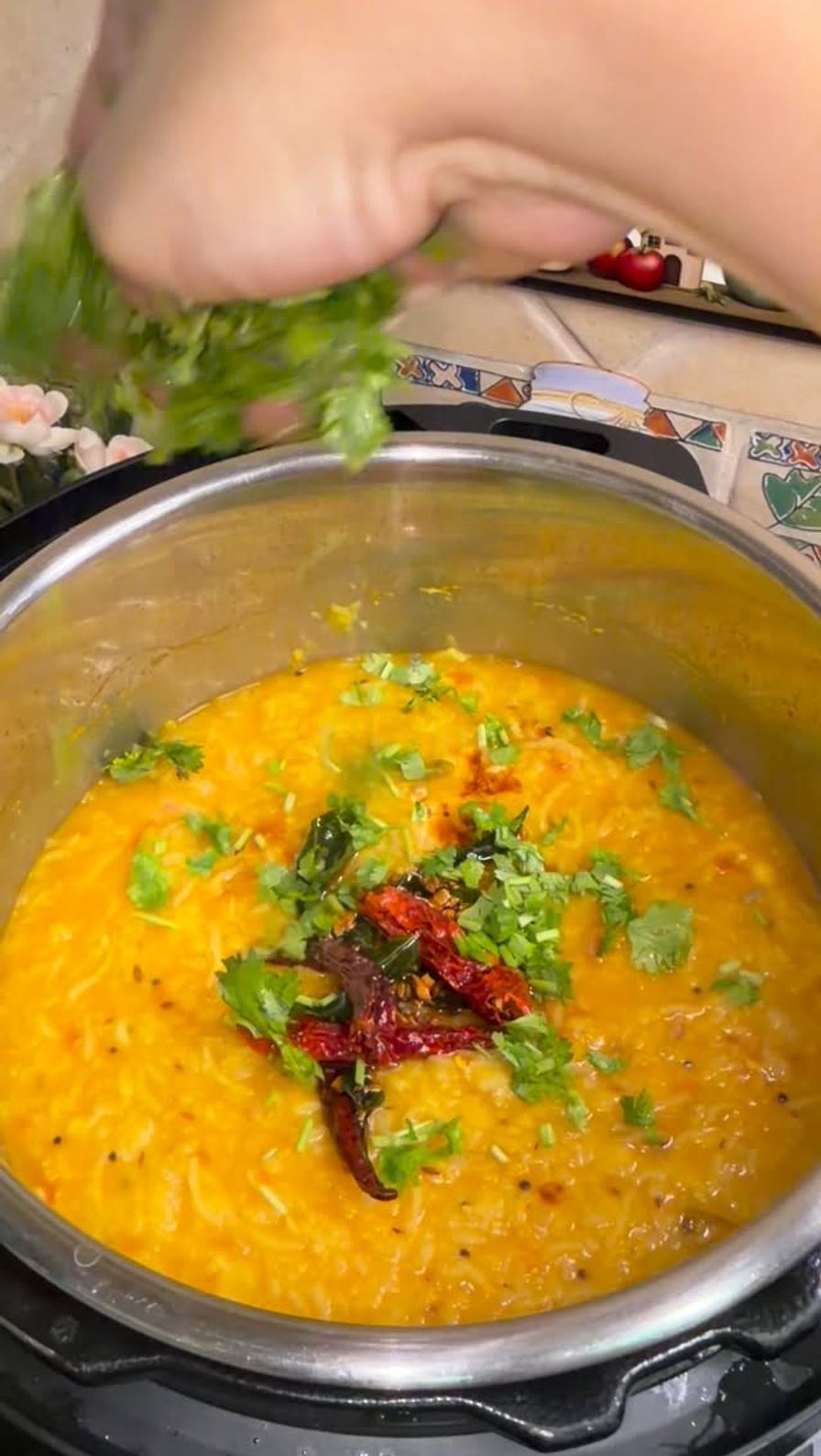 Golden dal khichdi topped with a red chilli and curry leaf ghee tempering