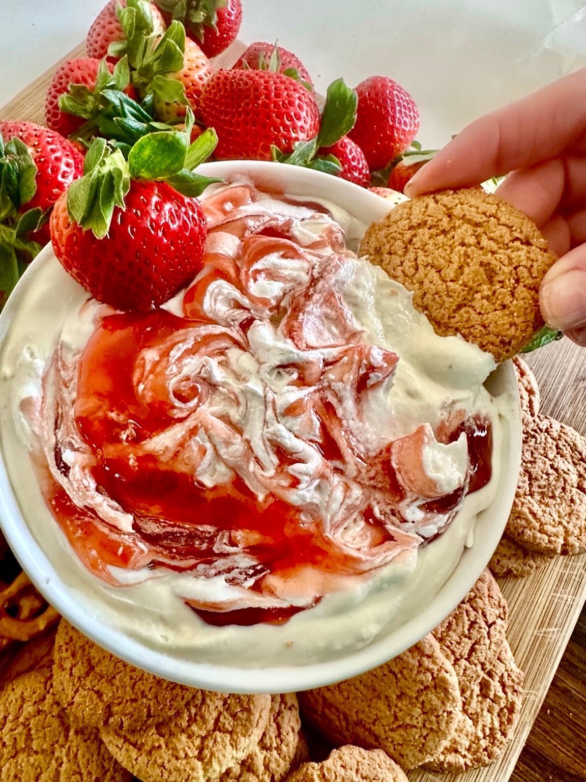 Fluffy strawberry cheesecake dip swirled with strawberry jam