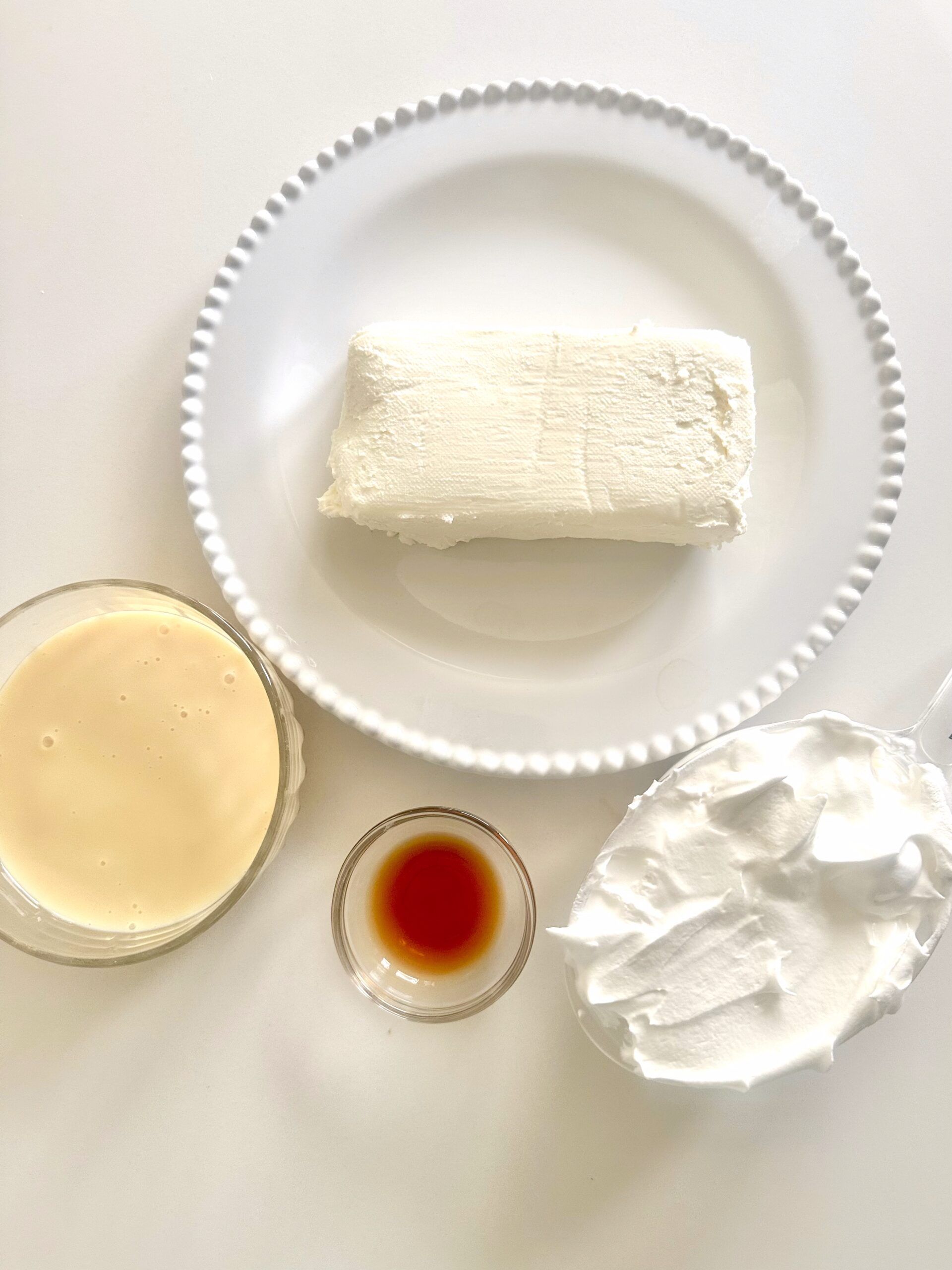 Four ingredients arranged before making no-bake cheesecake dip