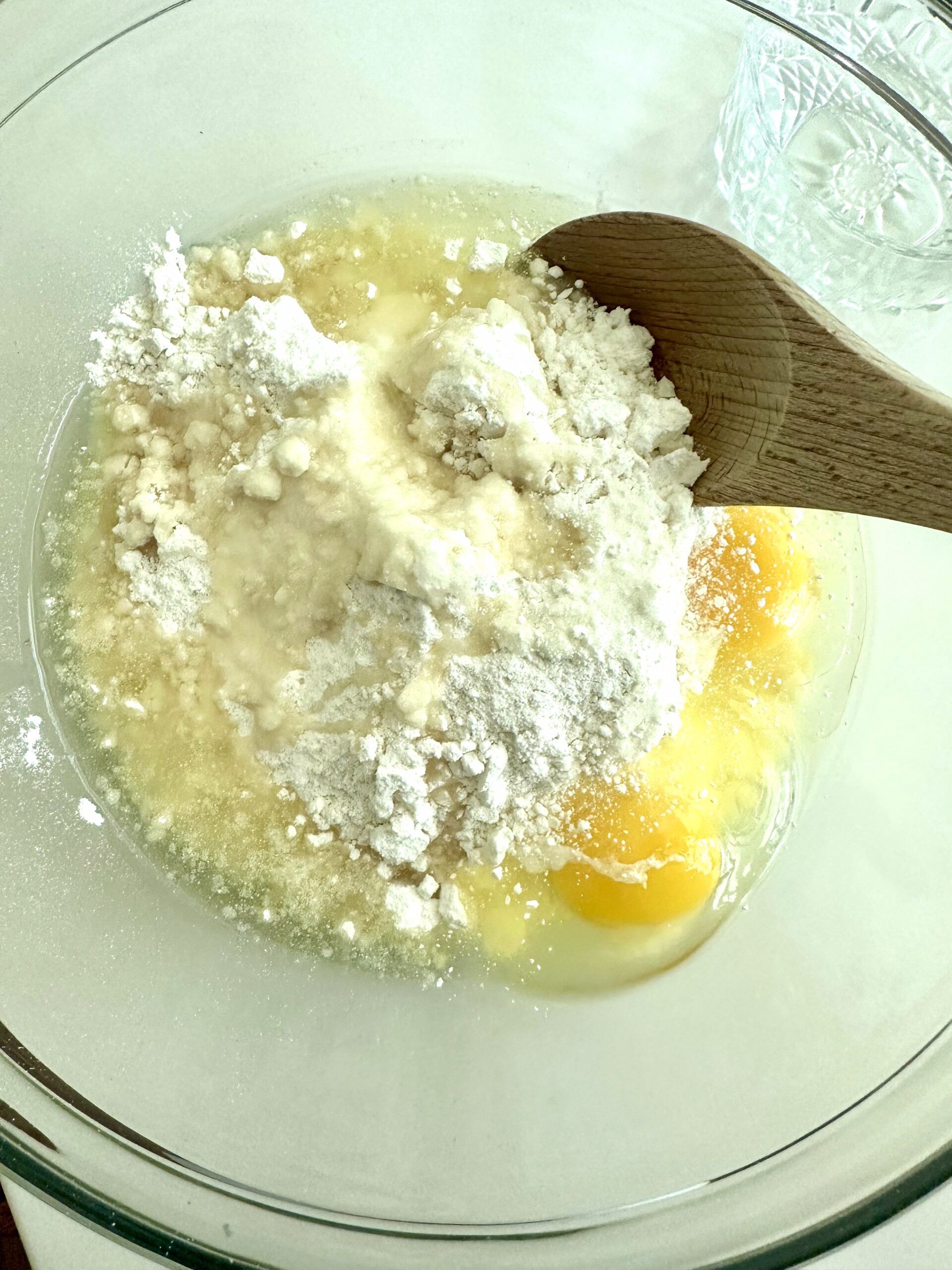 White cake mix cookie dough being stirred in a bowl