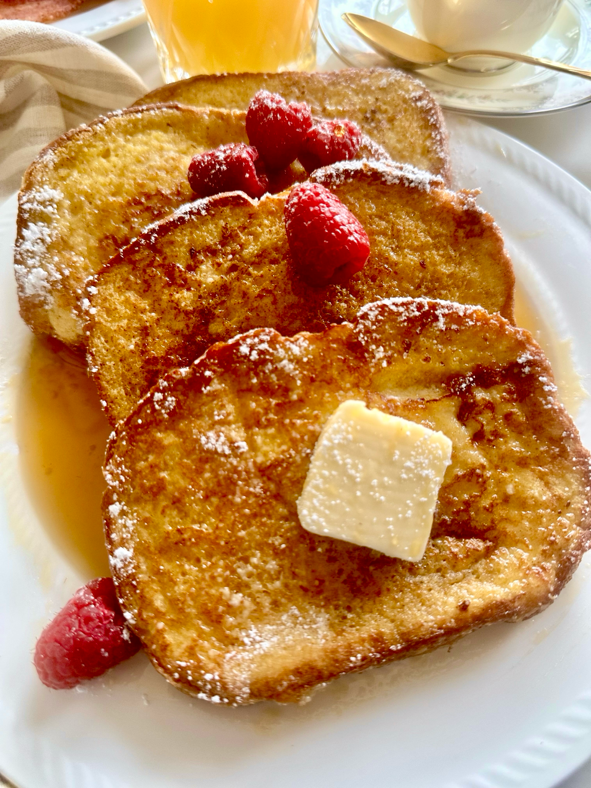 Brioche, eggs, milk, cinnamon, vanilla, butter, berries, and maple syrup for French toast