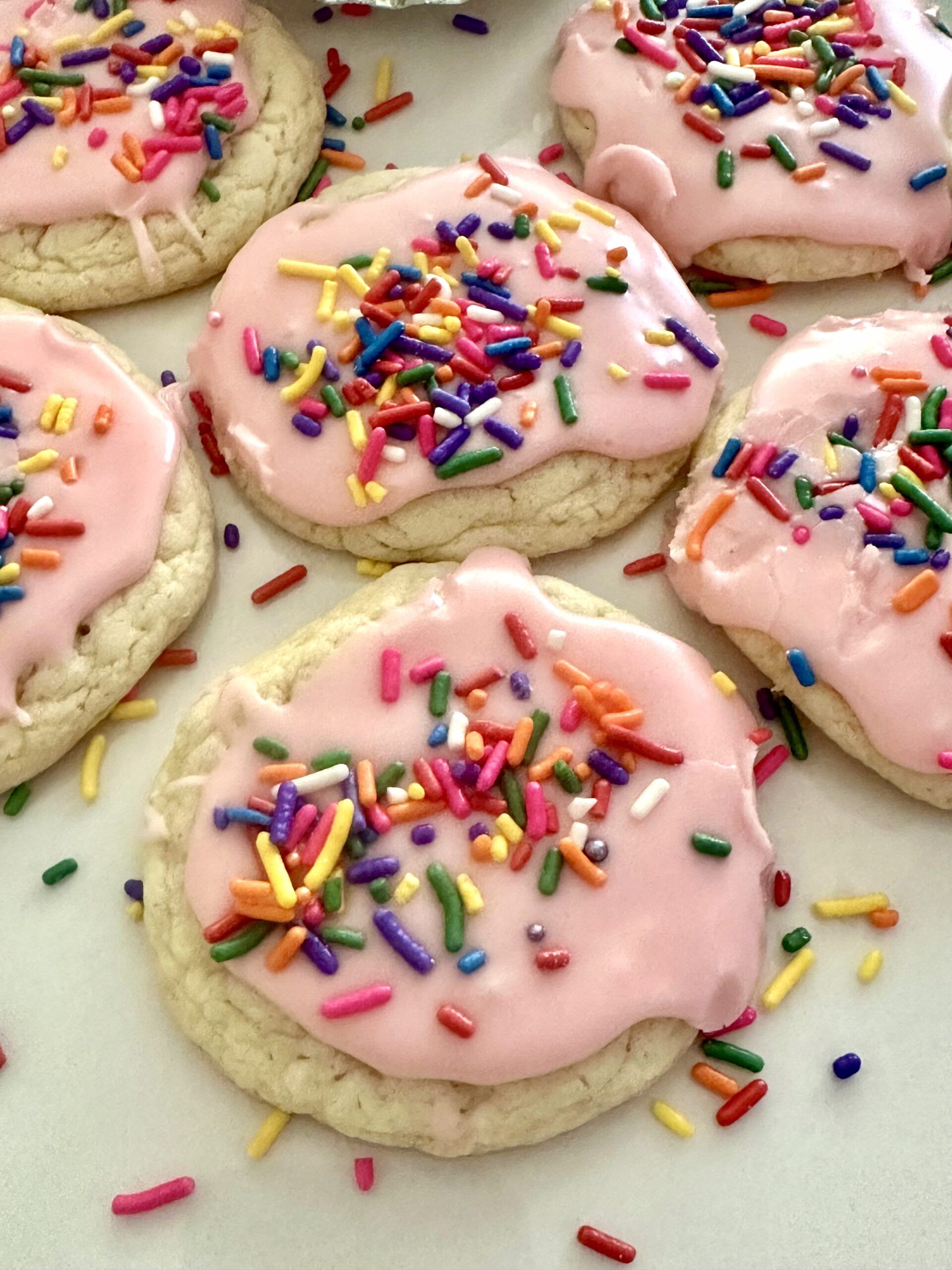 Pink glazed cake mix cookies ready for a spring table