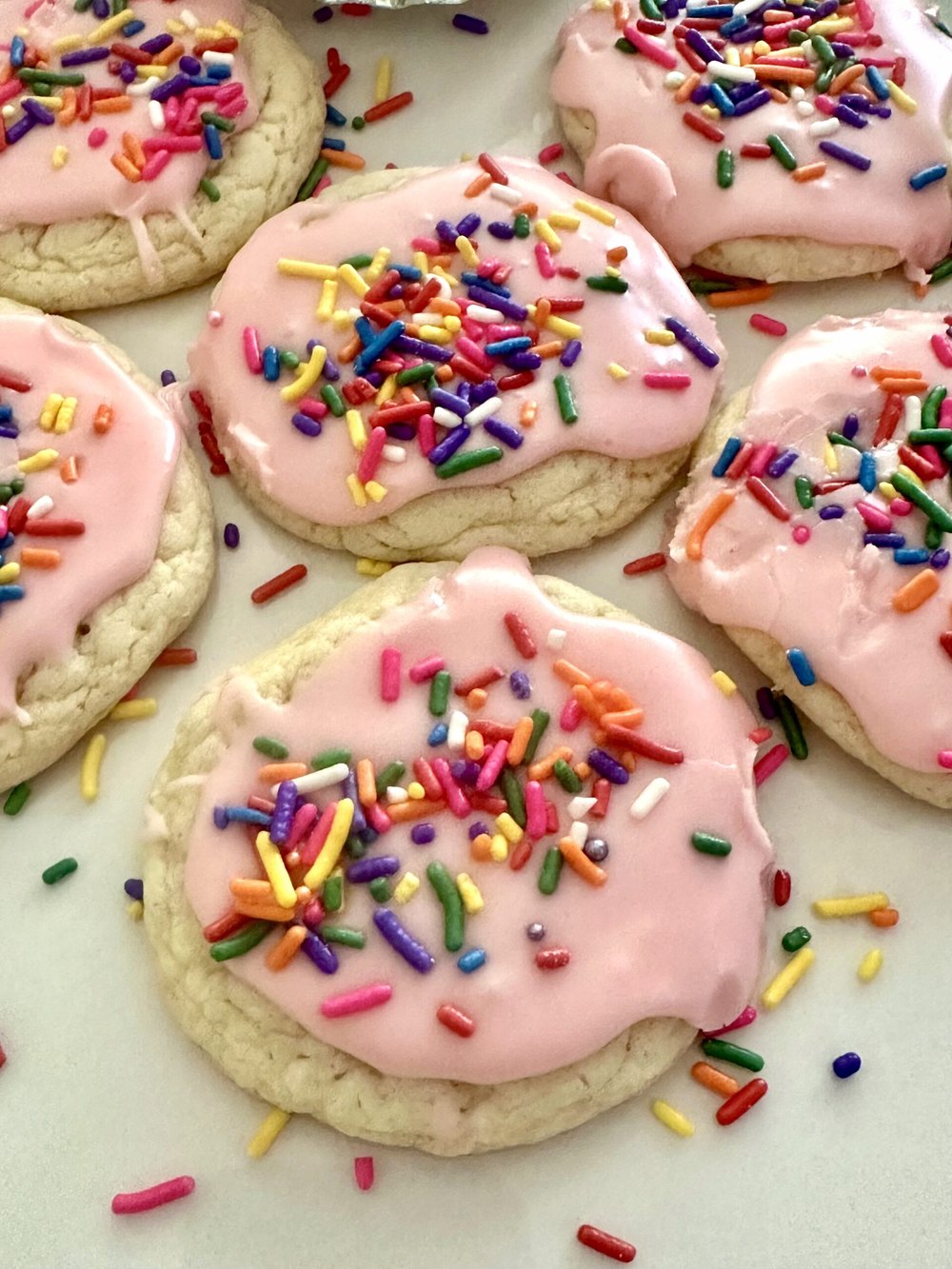 Pink glazed cake mix cookies ready for a spring table