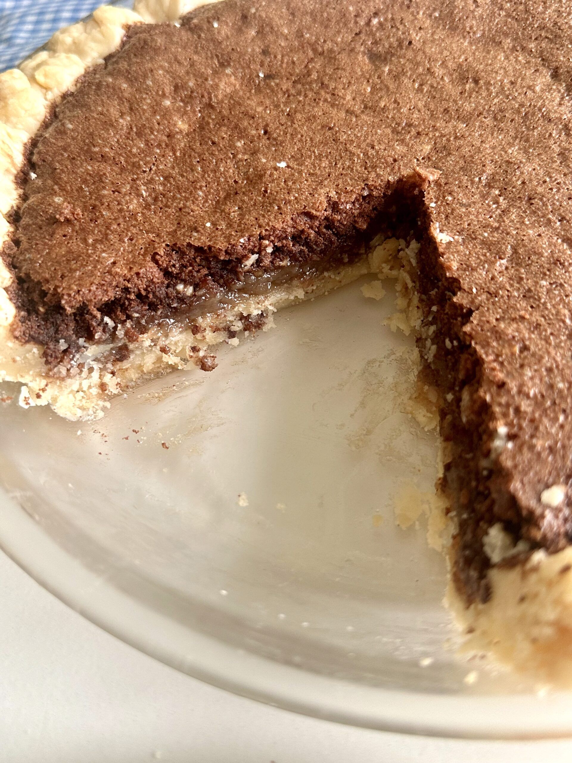 Chocolate fudge pie served with a creamy topping