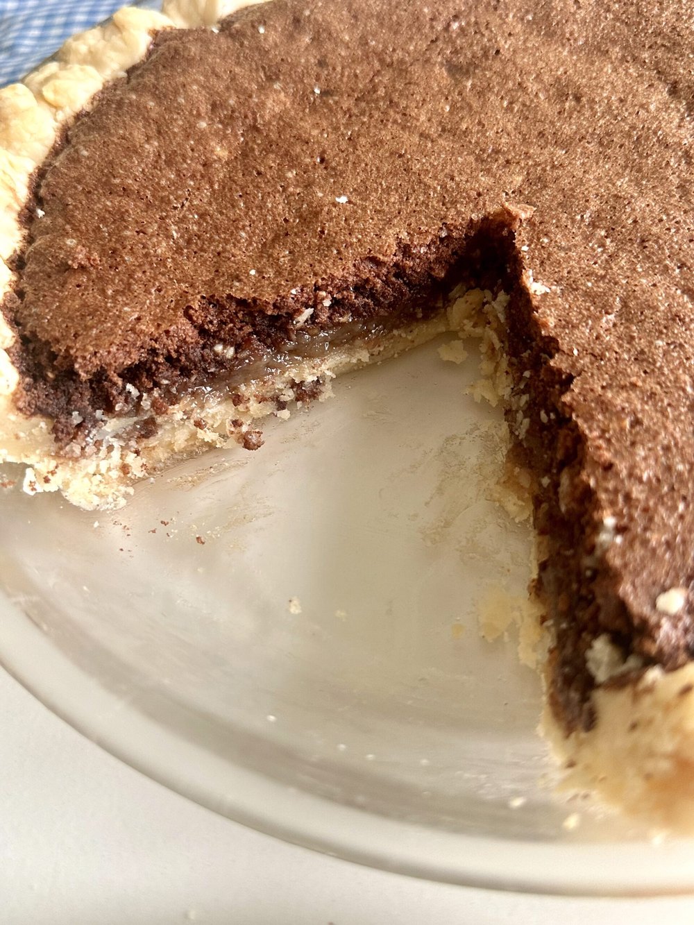 Chocolate fudge pie served with a creamy topping