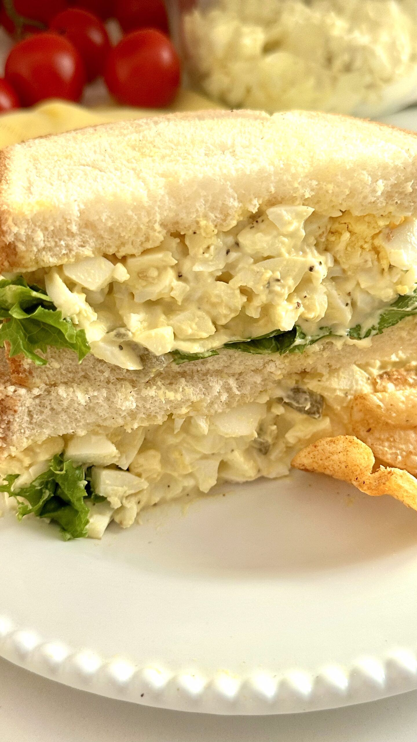 A tall stack of Southern egg salad sandwiches on soft white bread