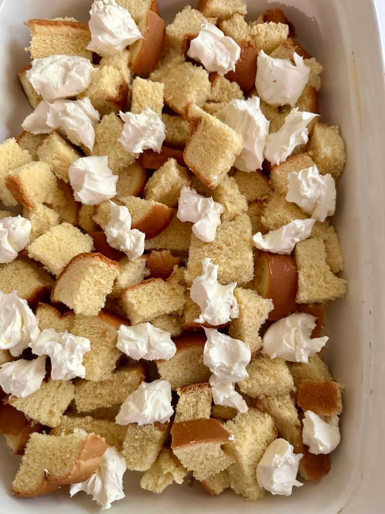 Brioche cubes layered in a casserole dish