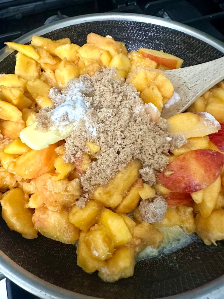 Peaches cooking with butter, sugar, cinnamon, and vanilla