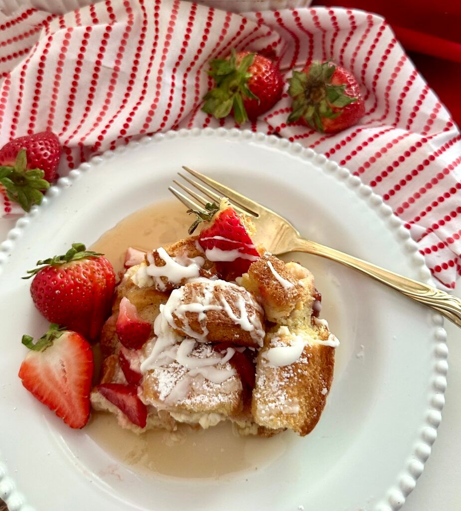 Strawberry French toast casserole finished with vanilla cream glaze