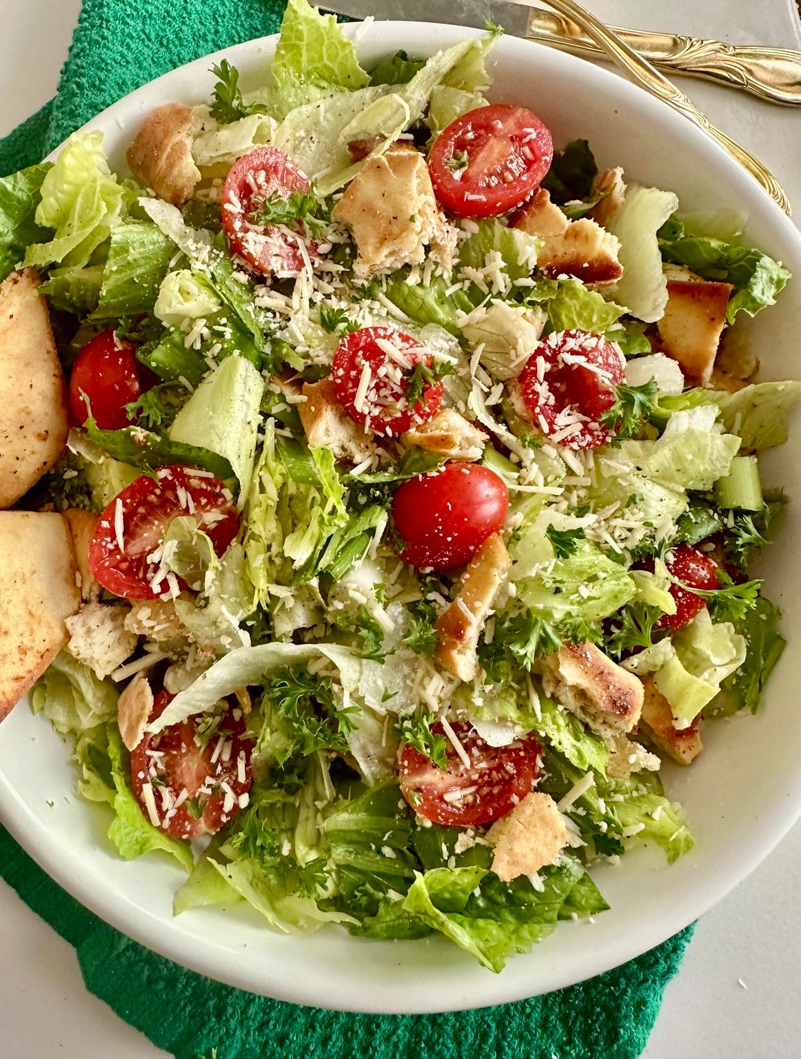 Green Jacket Salad with crisp lettuce, tomatoes, Parmesan, and toasted pita chips