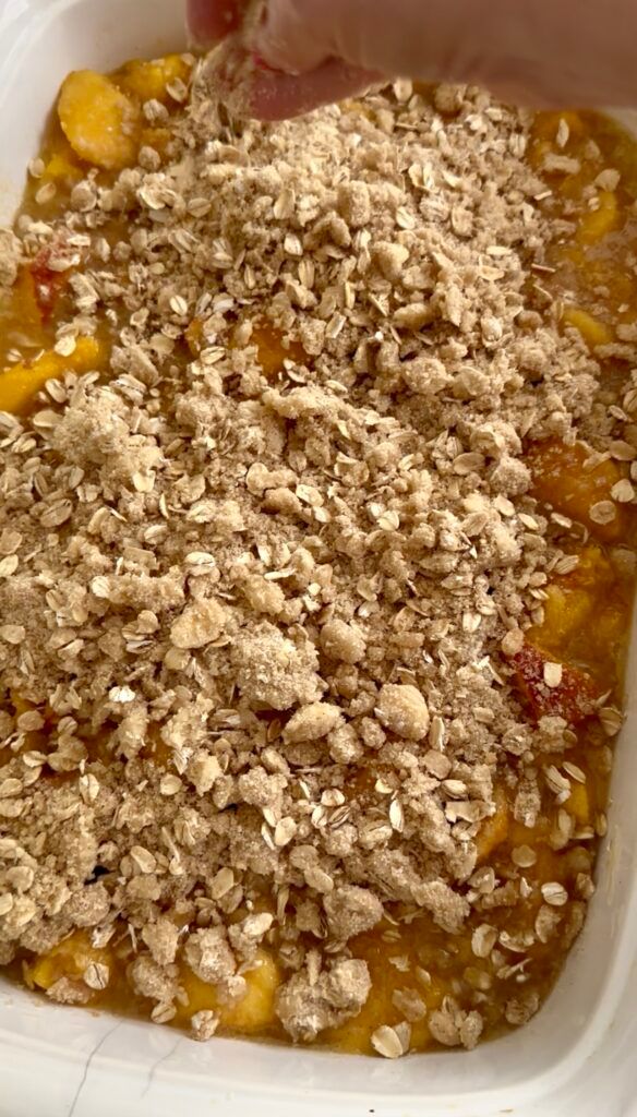 Freshly baked peach crisp with a golden oatmeal topping