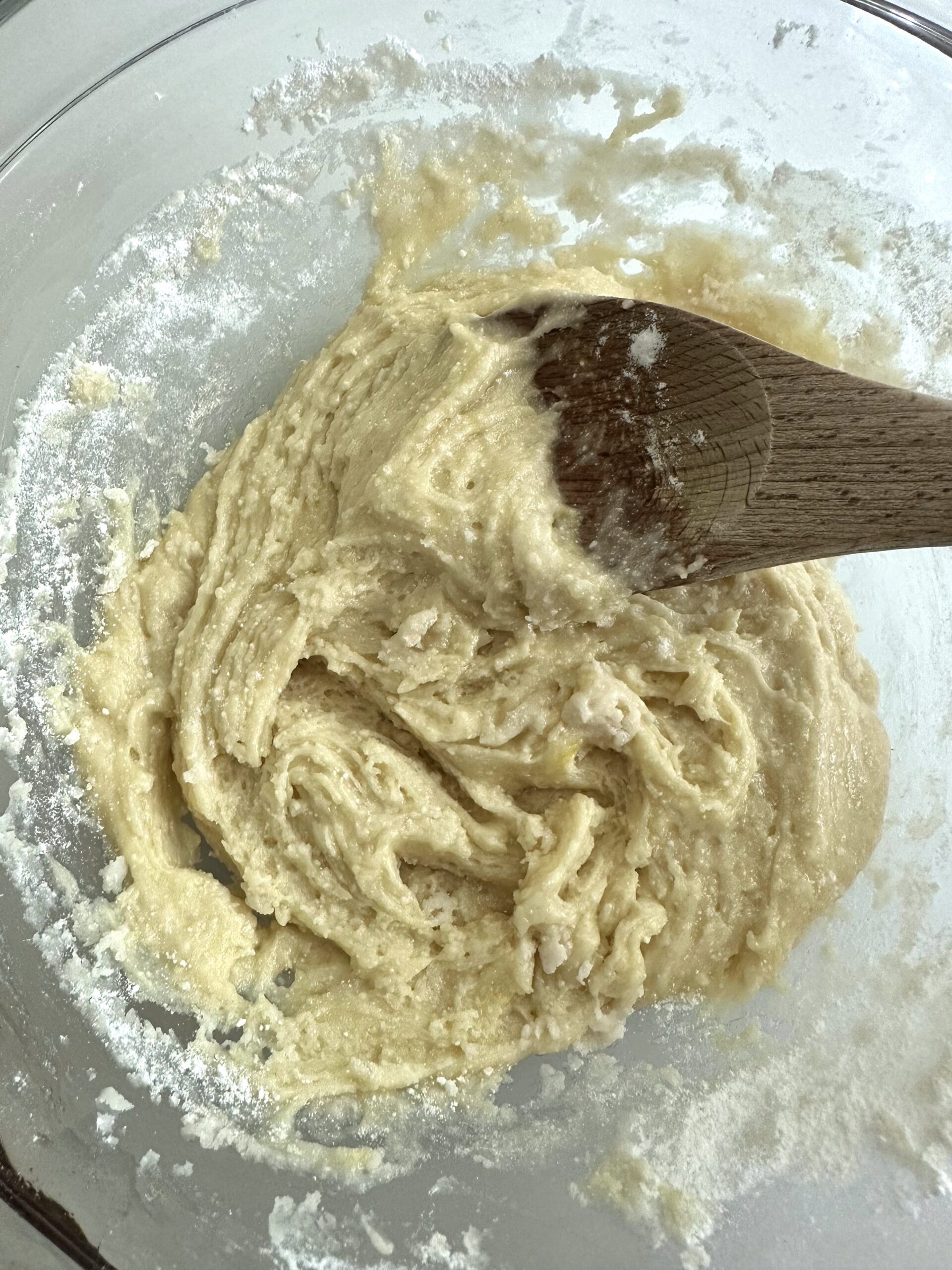 Portions of cake mix cookie dough on a lined baking sheet