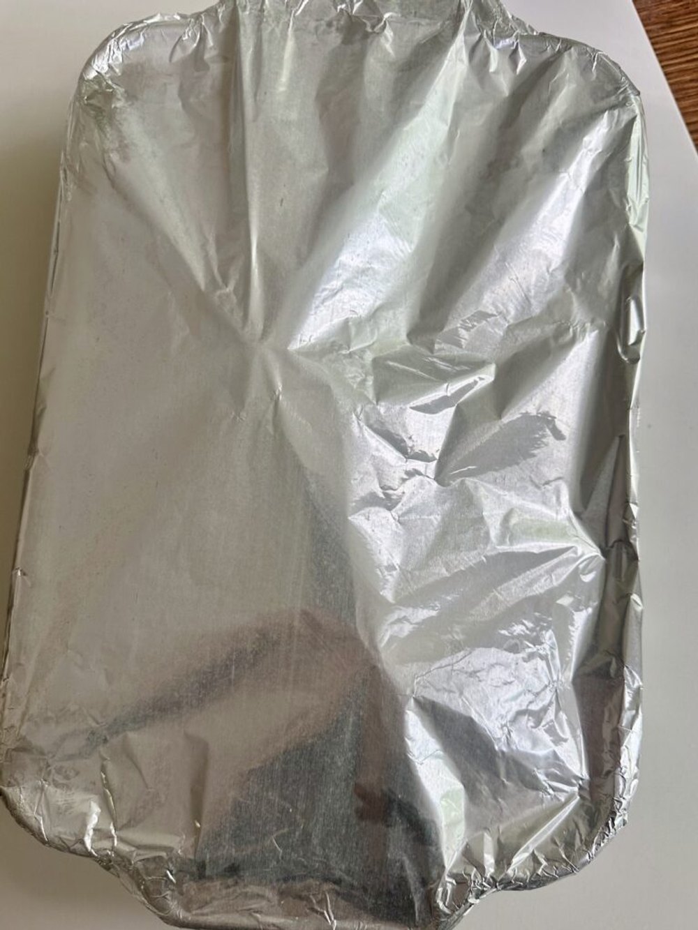 Chicken breasts covered tightly with foil before baking