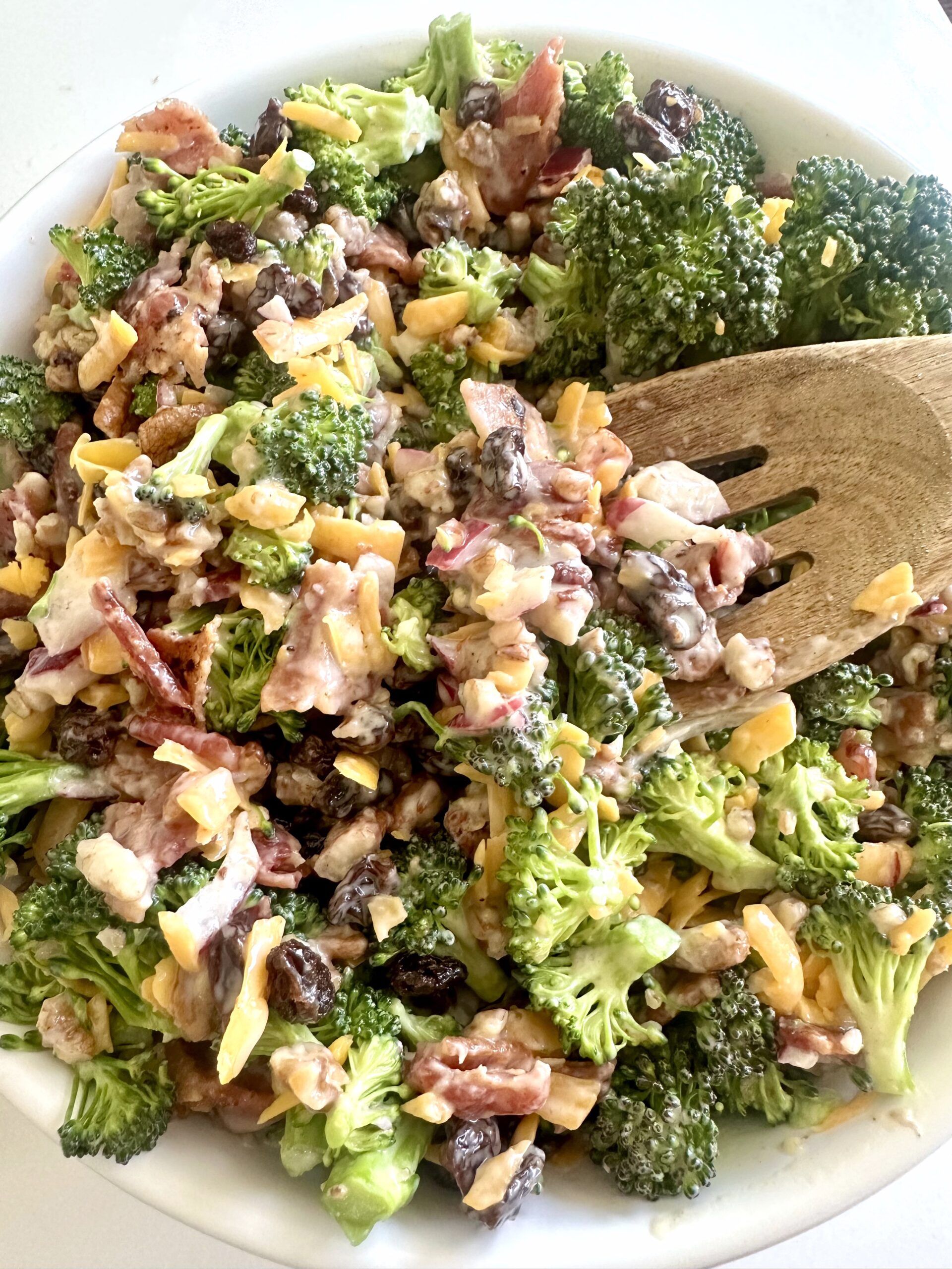 Broccoli raisin salad with bacon, cheddar cheese, pecans, and creamy dressing