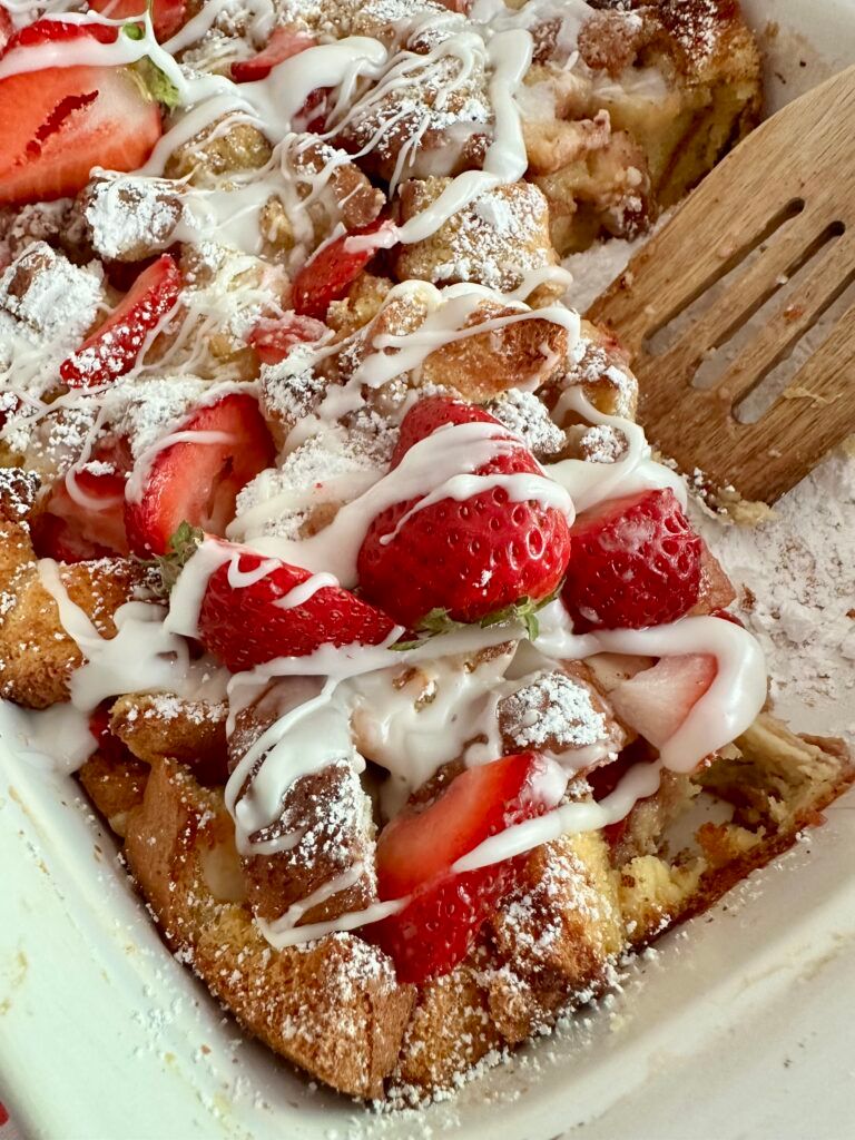 French toast casserole with strawberries and vanilla glaze