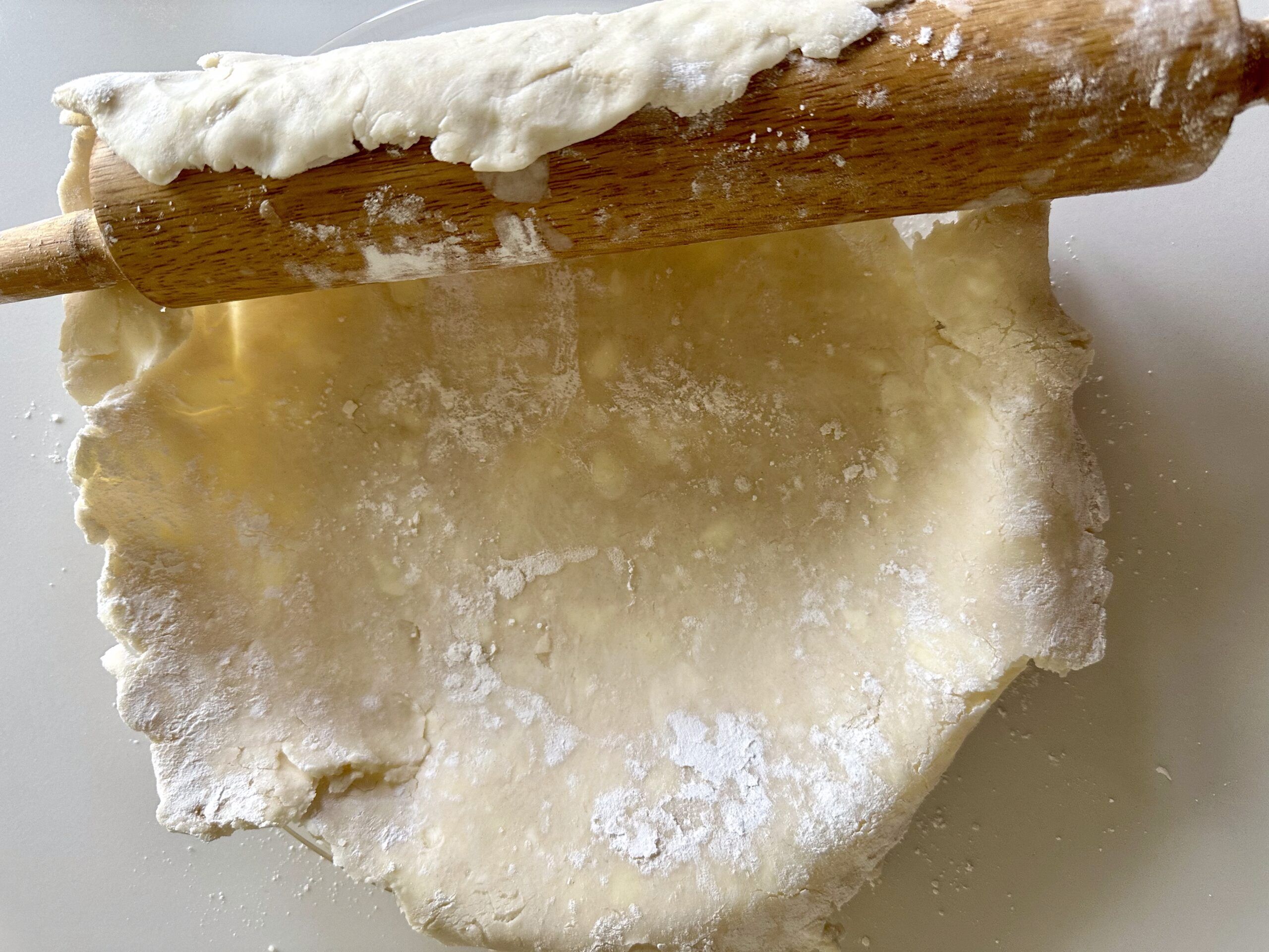 Homemade pie crust with a hand-crimped edge in a pie plate