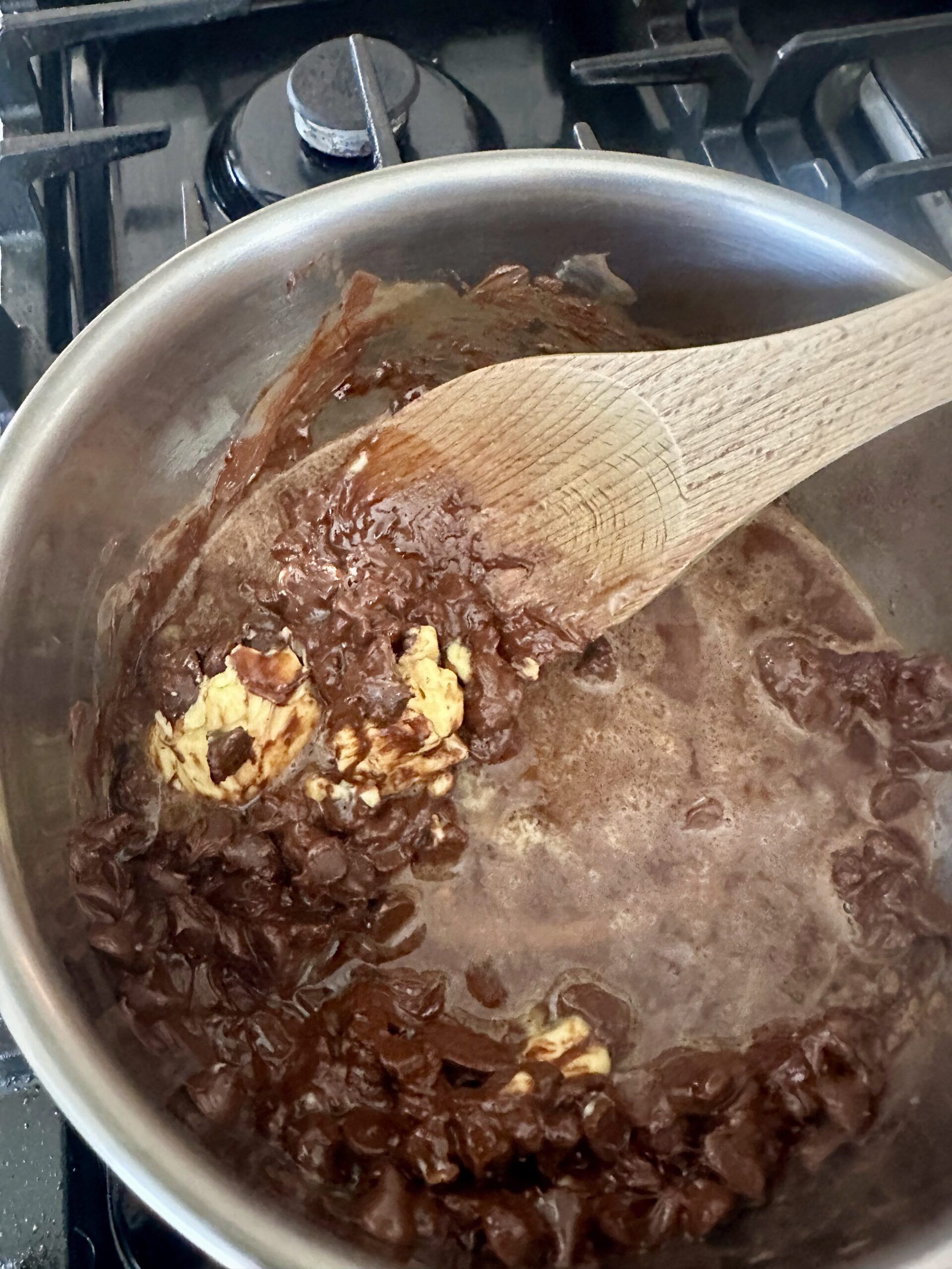 Chocolate chips, butter, and Guinness melting in a saucepan