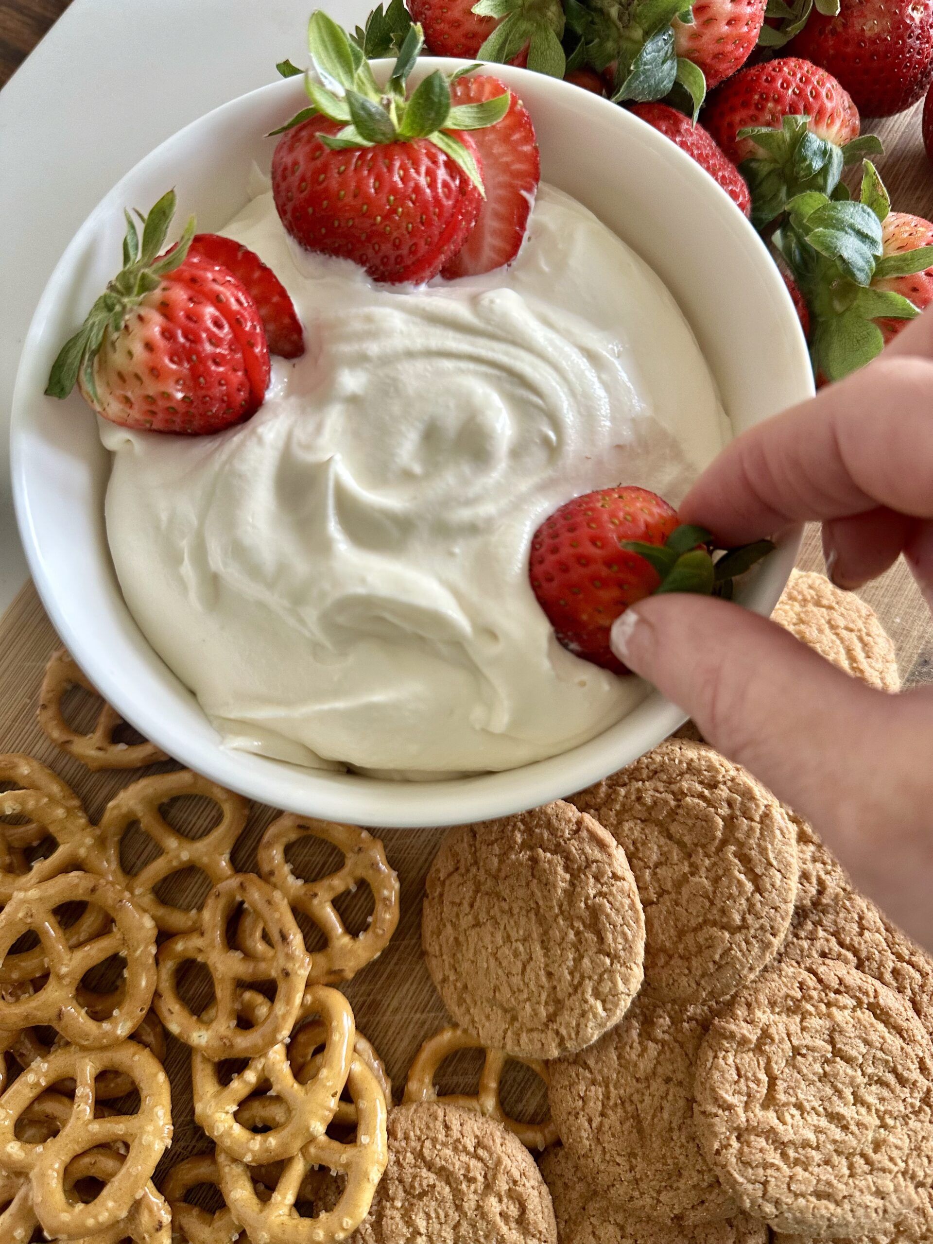Finished no-bake cheesecake dip surrounded by favorite dippers