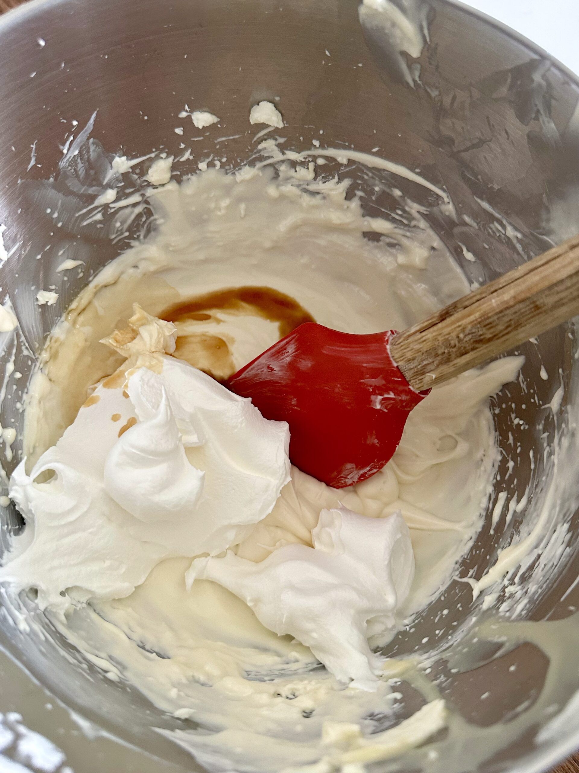 Whipped topping being folded into cheesecake dip