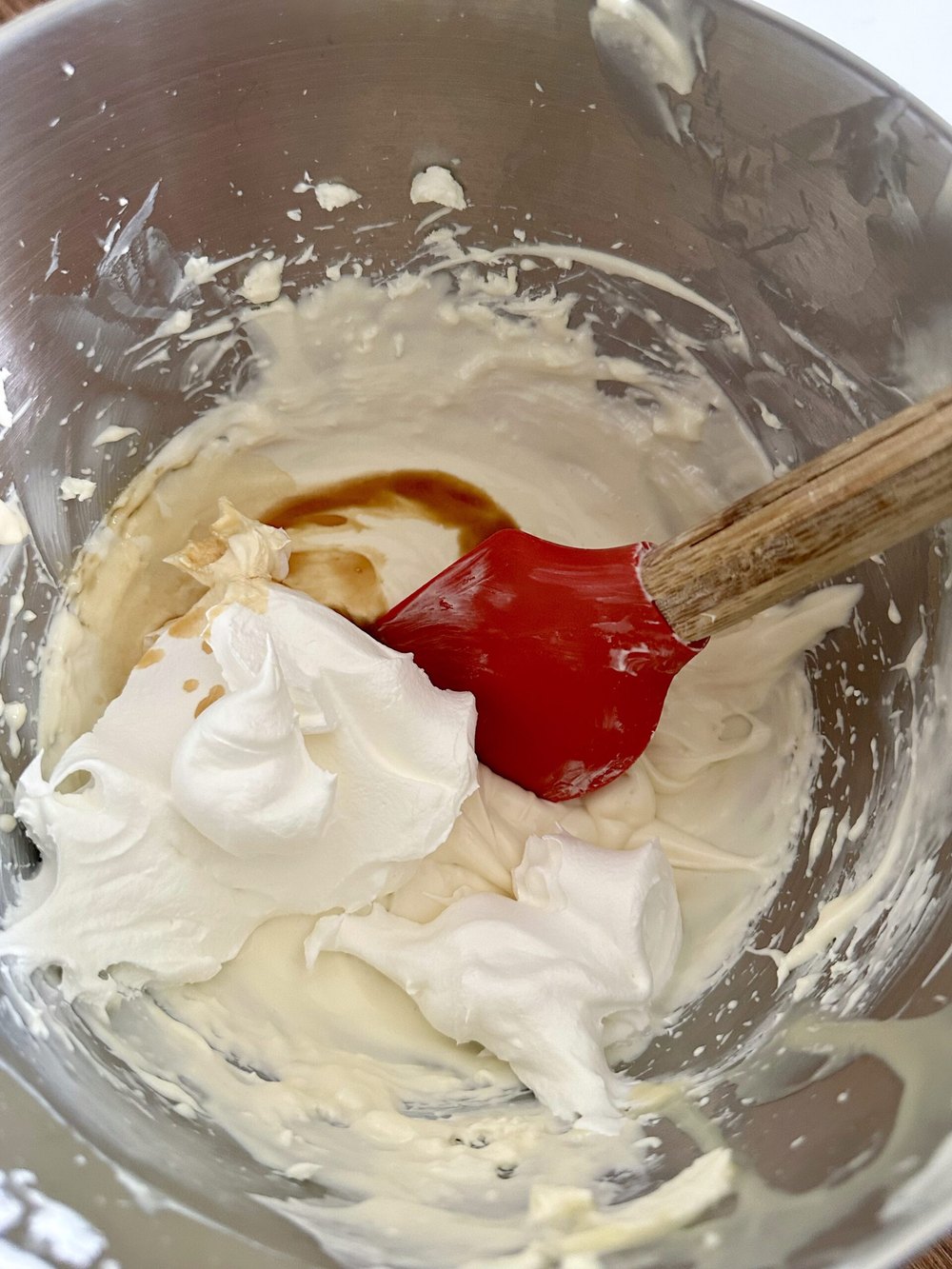 Whipped topping being folded into the cheesecake mixture