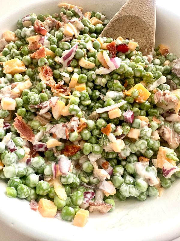 Creamy Southern pea salad with bacon, cheddar cheese, and red onion
