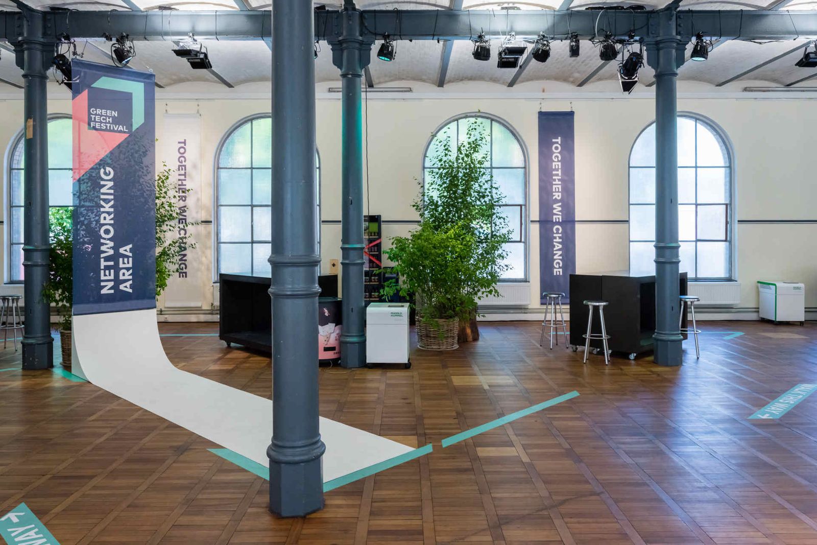 Industrial event location with long, branded banners rolled out along the floor.