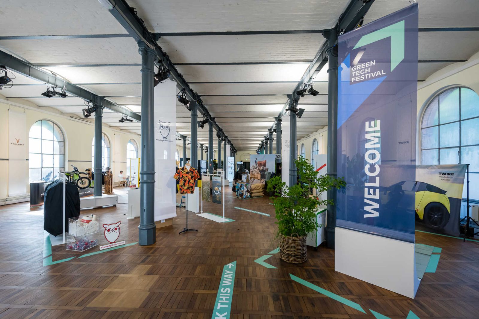 Long hall with product presentations and banners.
