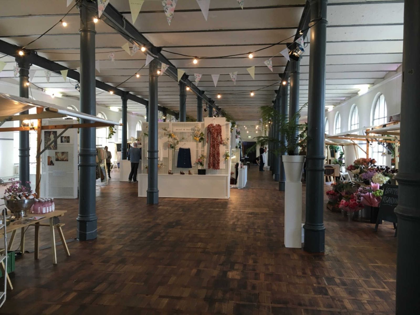 Large hall with flower stands and product presentations.