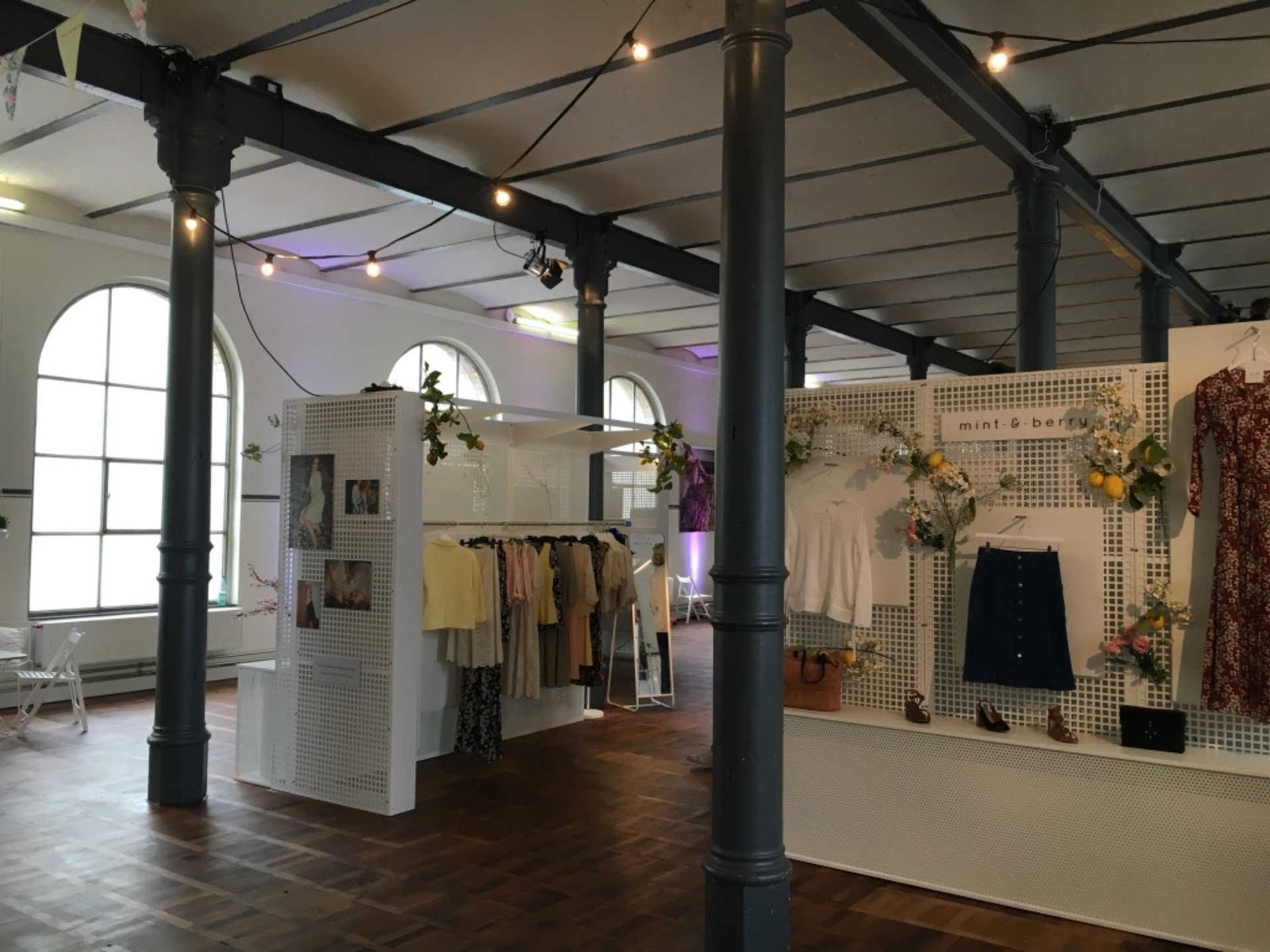 Industrial hall with fashion product presentations.