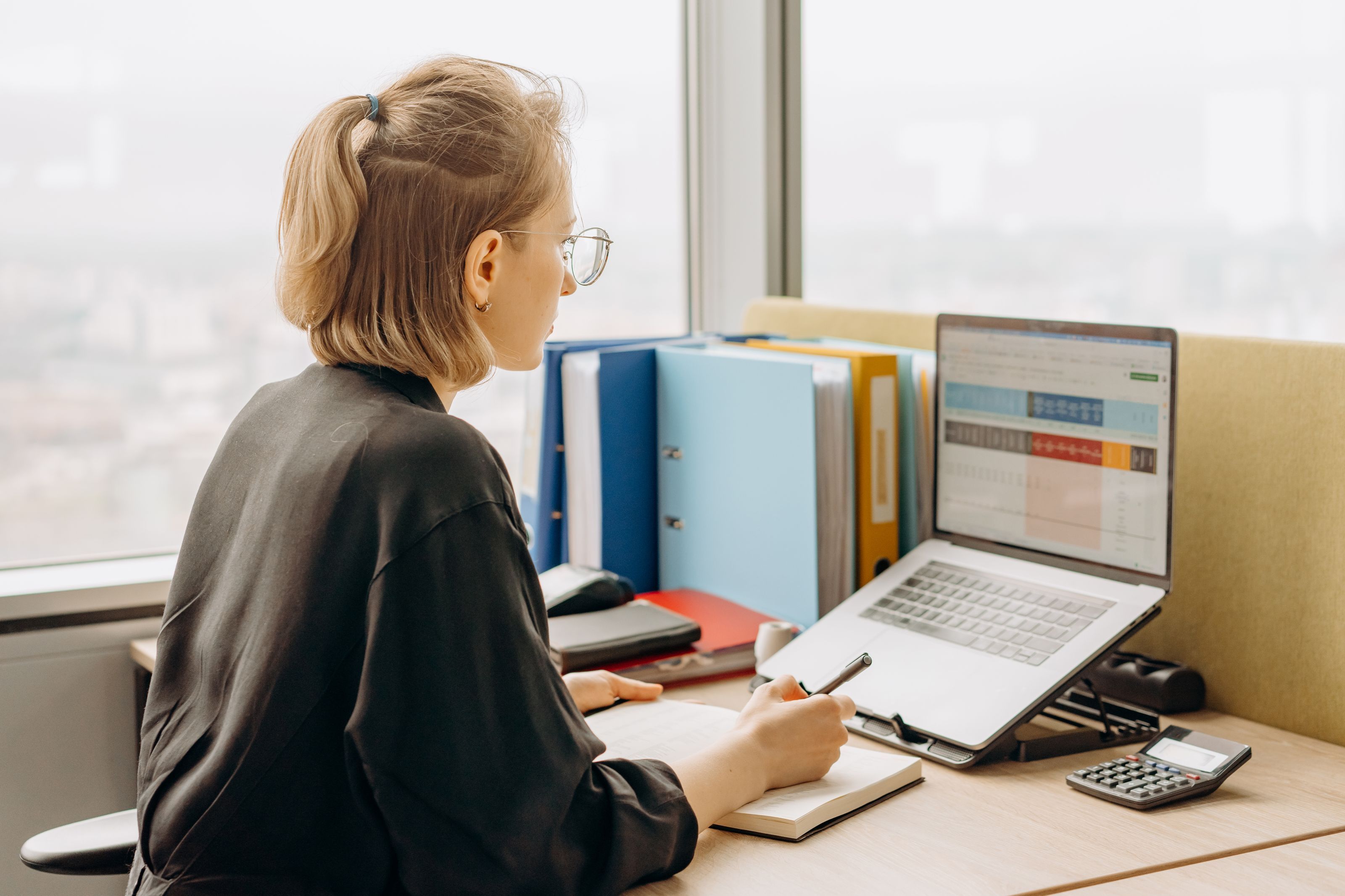 A member of staff working on a spreadsheet in an office