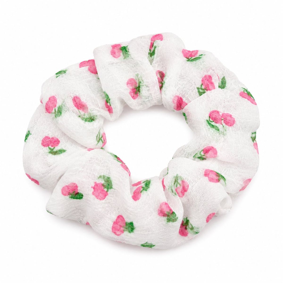A puffy white gauze scrunchie with an all-over pink cherry and green leaf print, photographed on a white background.