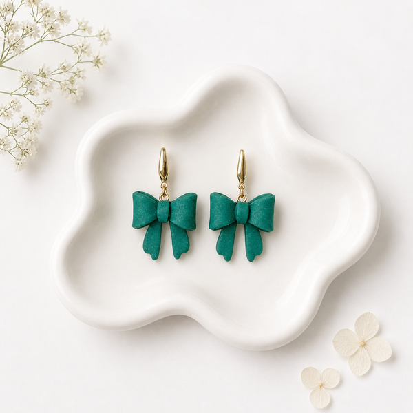 Teal green polymer clay bow dangle earrings with gold lever-back hooks