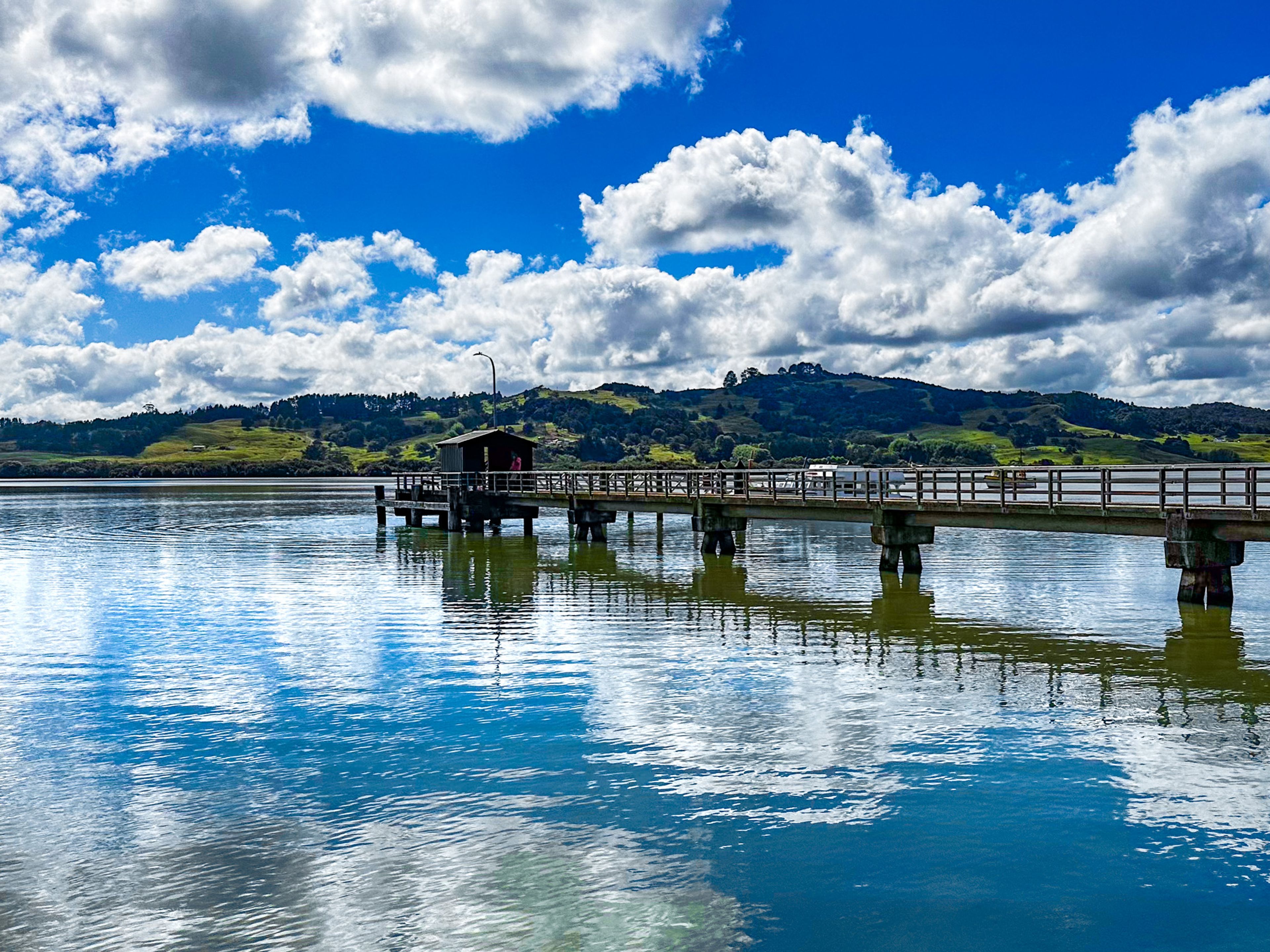 reflections in the harbour beside the Kohukohu pier