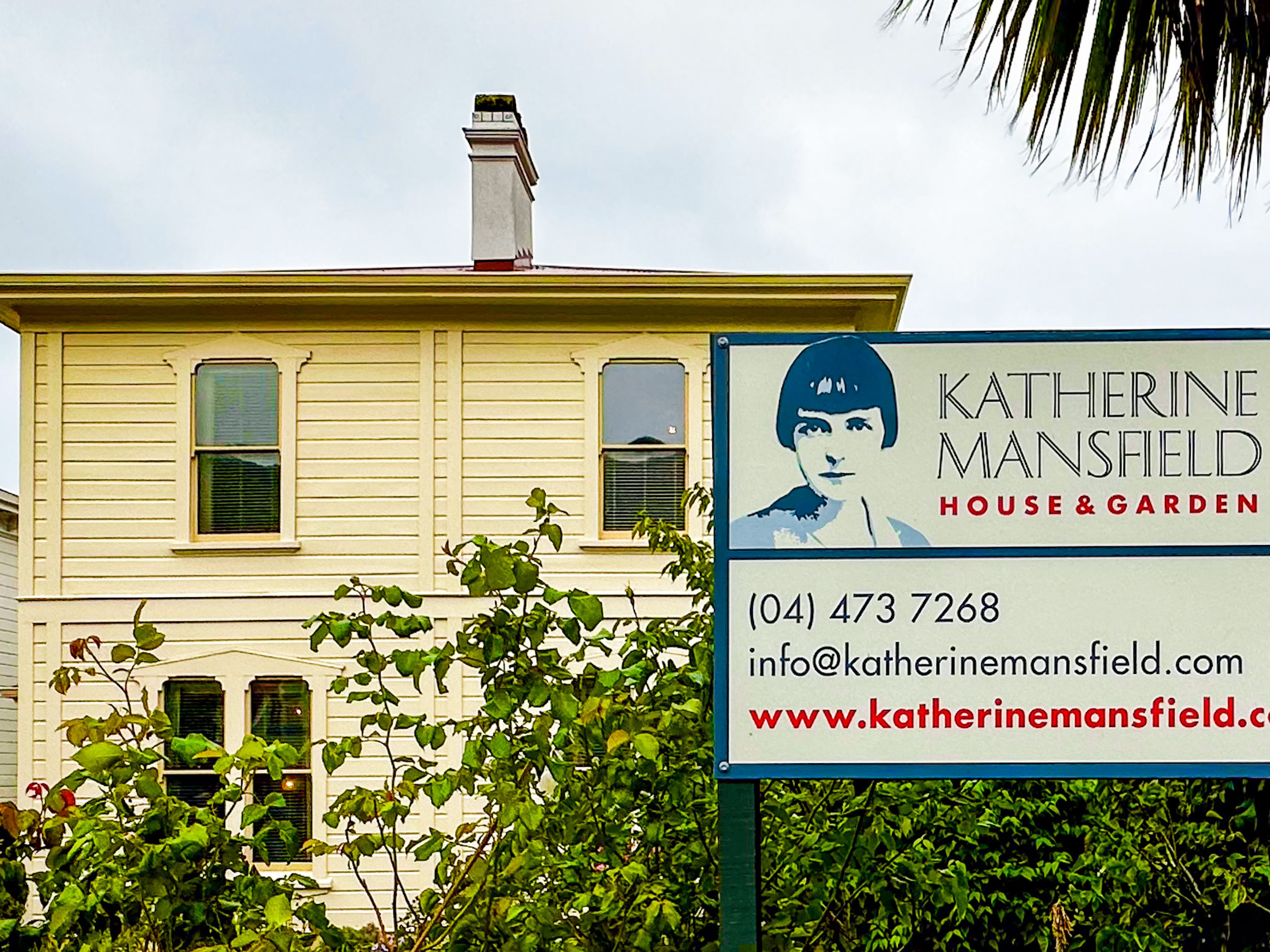 portrait of katheirne mansfield on the sign in front of the house