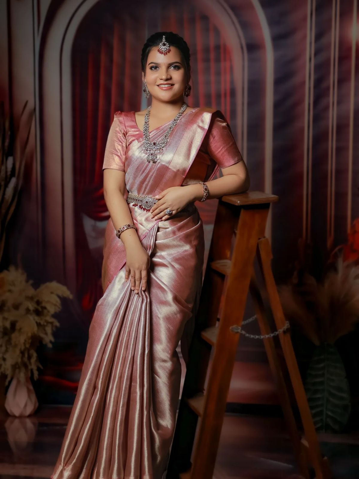 Bride in a rose-gold kanjeevaram silk saree with silver bridal jewellery