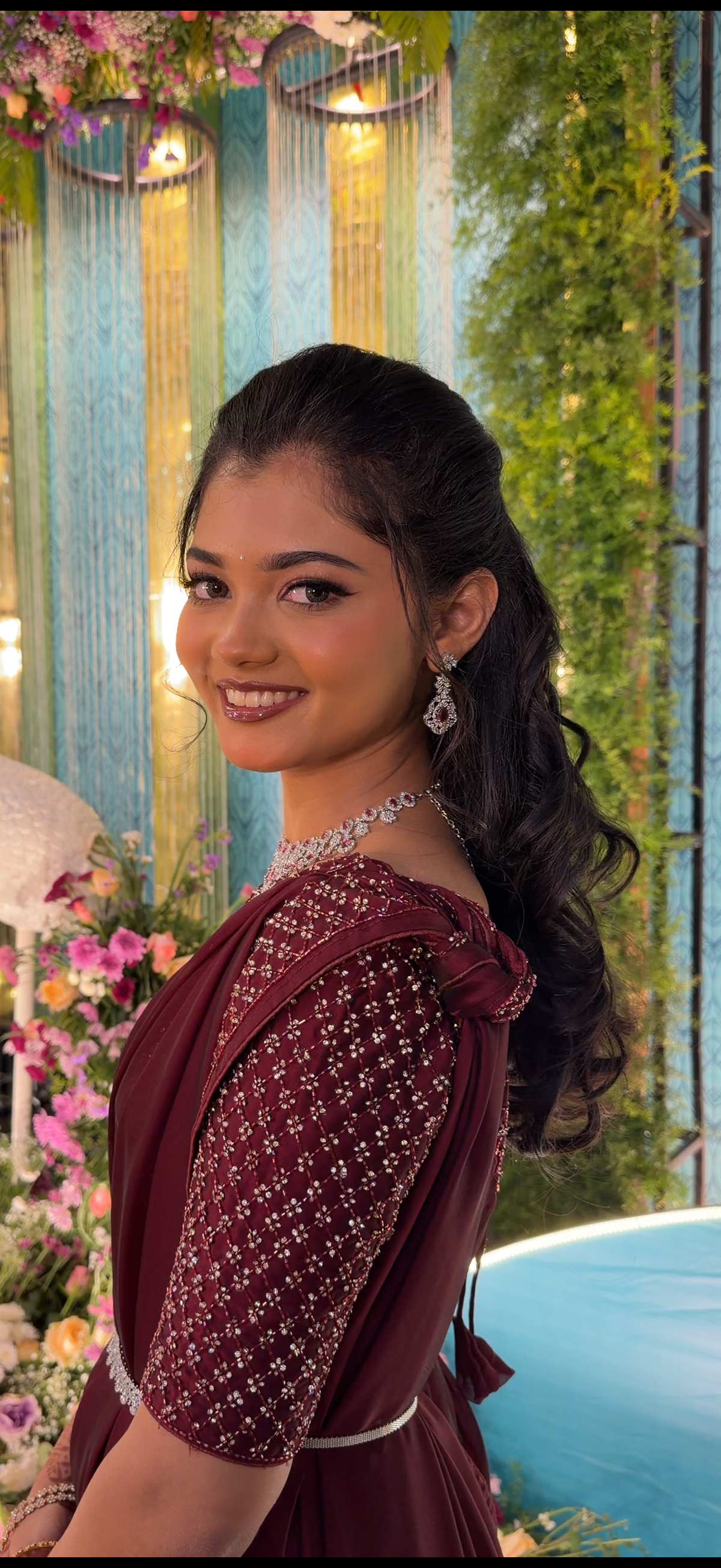 Bridal client Sowndharya in a maroon silk drape with a diamond rivière