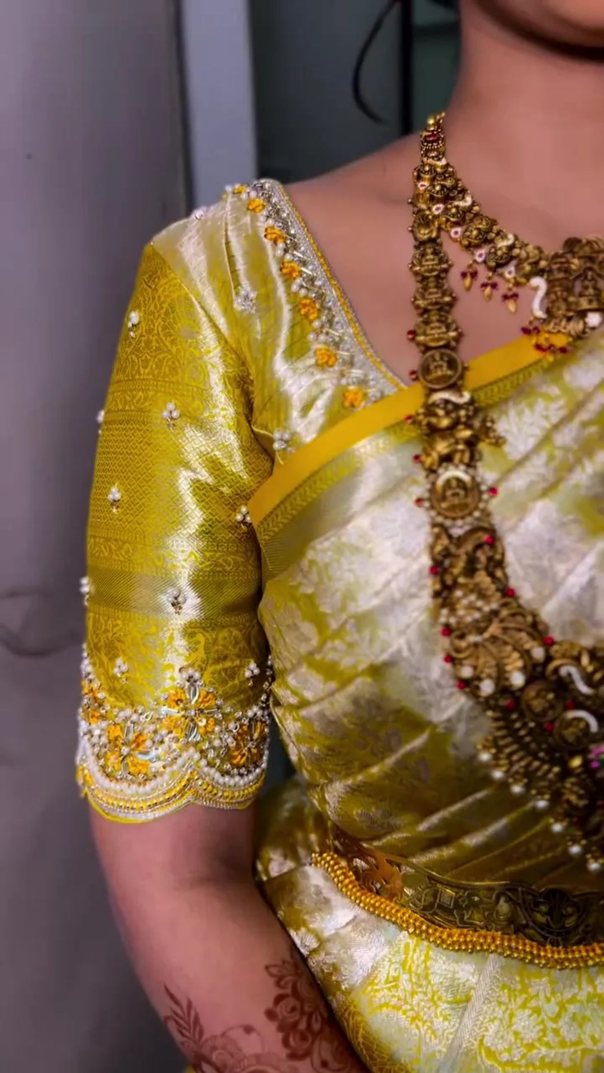 Bridal detail with chartreuse-gold zardosi blouse and temple jewellery