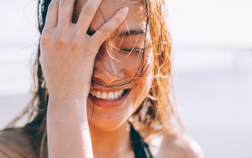 lady with wet hair smiling