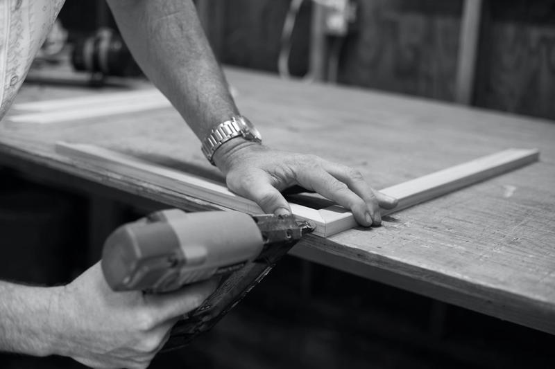 man drilling wooden frame