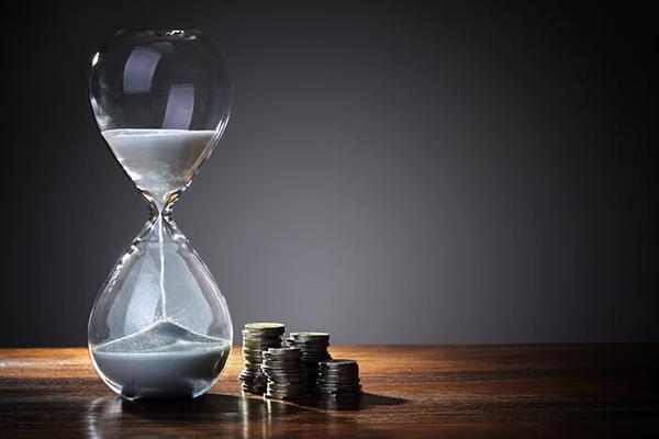 sand clock and coins