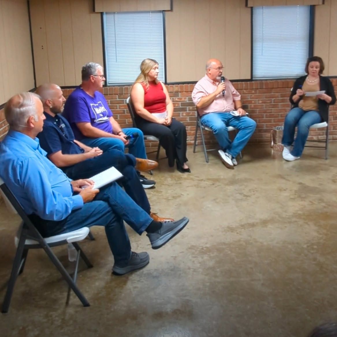 The full community town hall panel speaks with residents at the Ireland Sportsman’s Club.