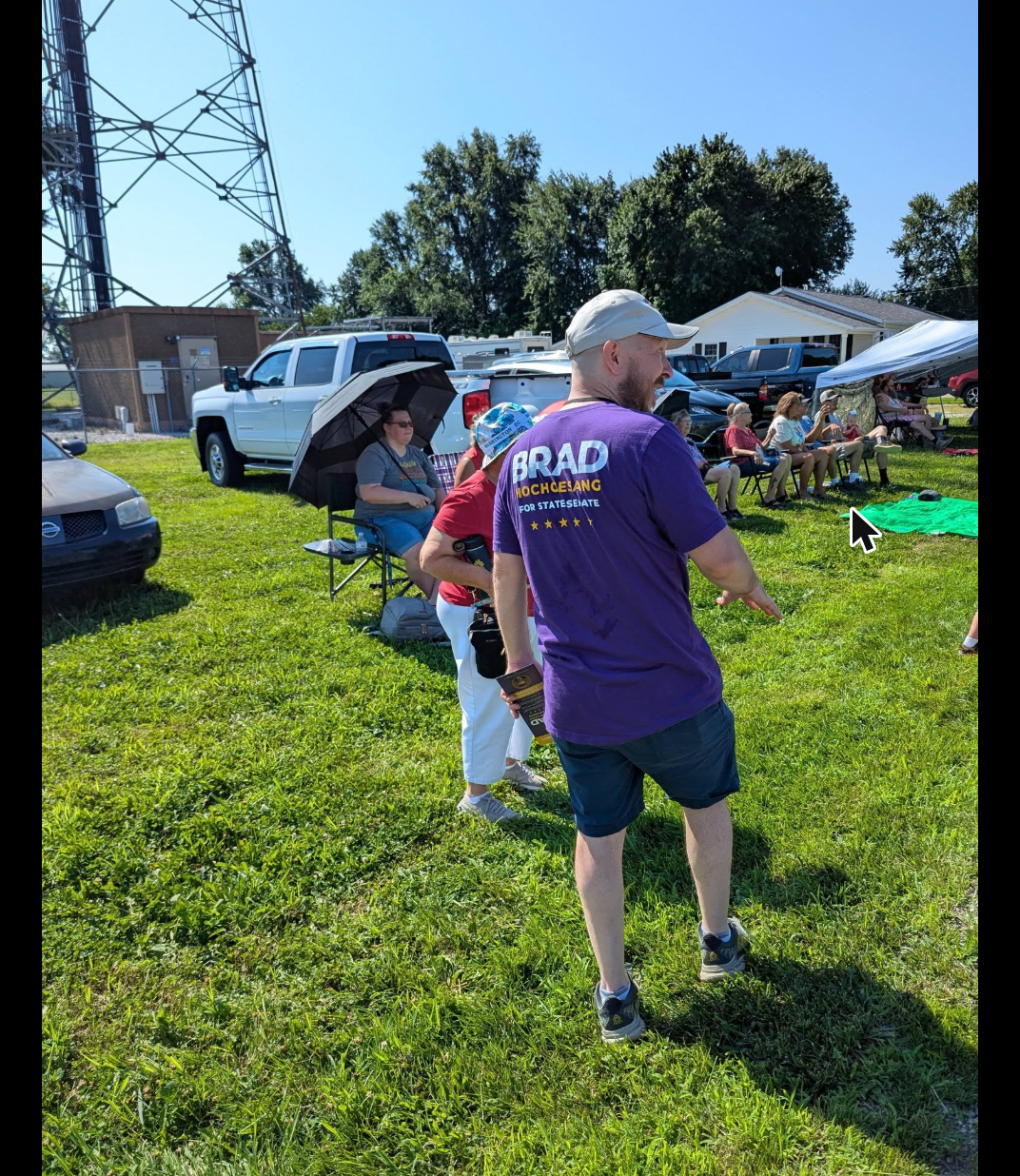 Brad Hochgesang in a campaign shirt greeting parade-goers in Otwell, Indiana