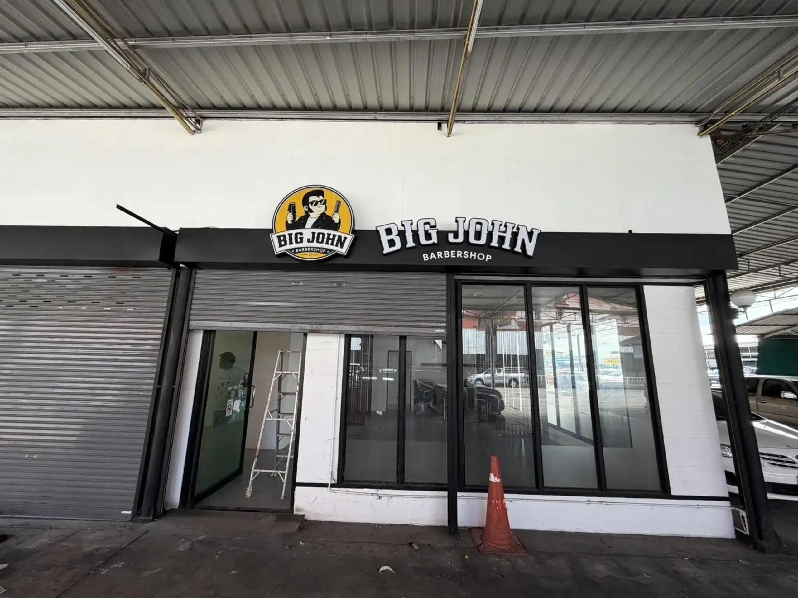Logo and raised lettering on a storefront sign