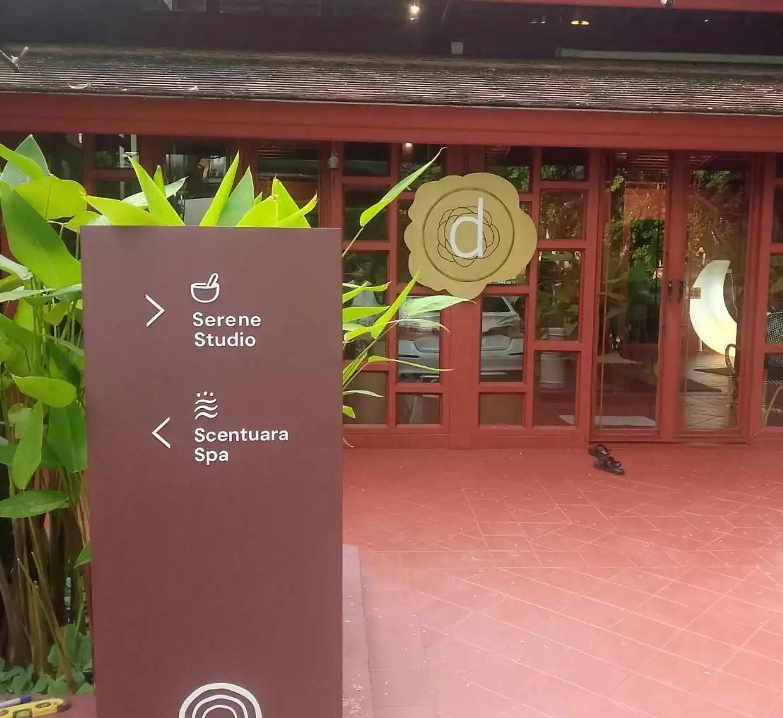 ป้ายชี้ทาง divana ระบุทิศทางไปยัง Serene Studio และ Scentuara Spa หน้าอาคาร | Directional wayfinding sign for divana pointing to Serene Studio and Scentuara Spa