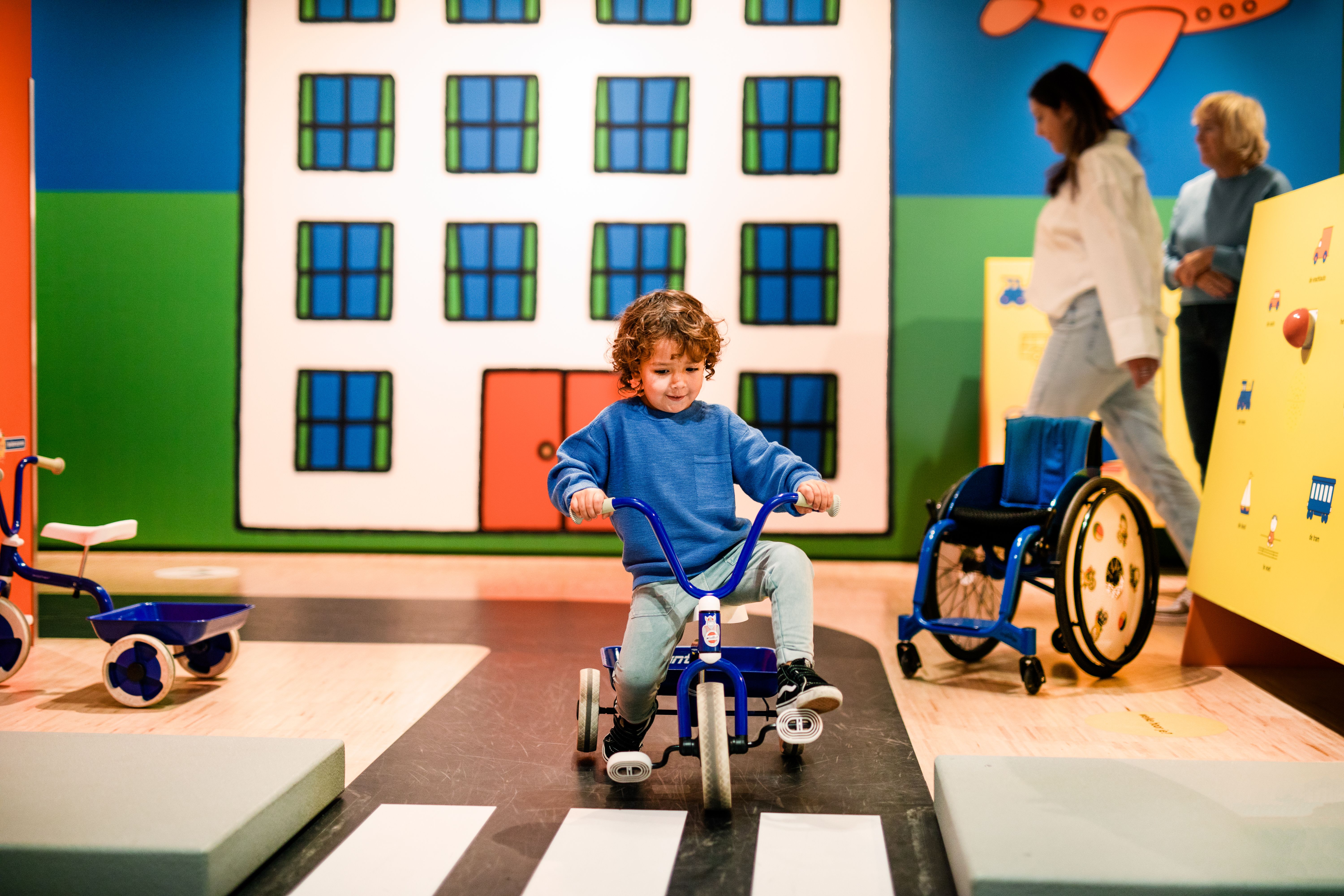 Child on a tricycle at the traffic square in the Miffy Museum 